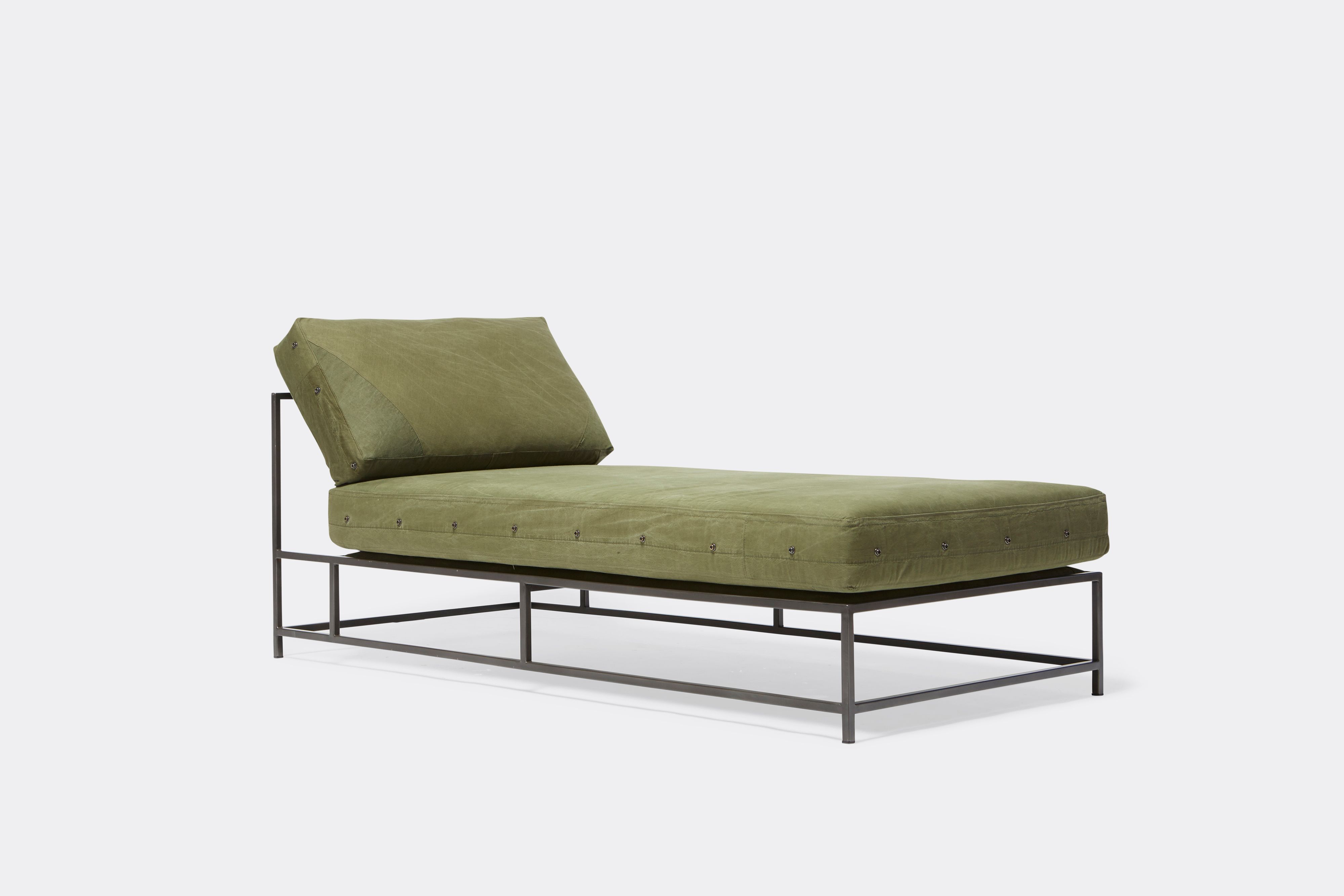 side view of military canvas chaise lounge with blackened steel frame