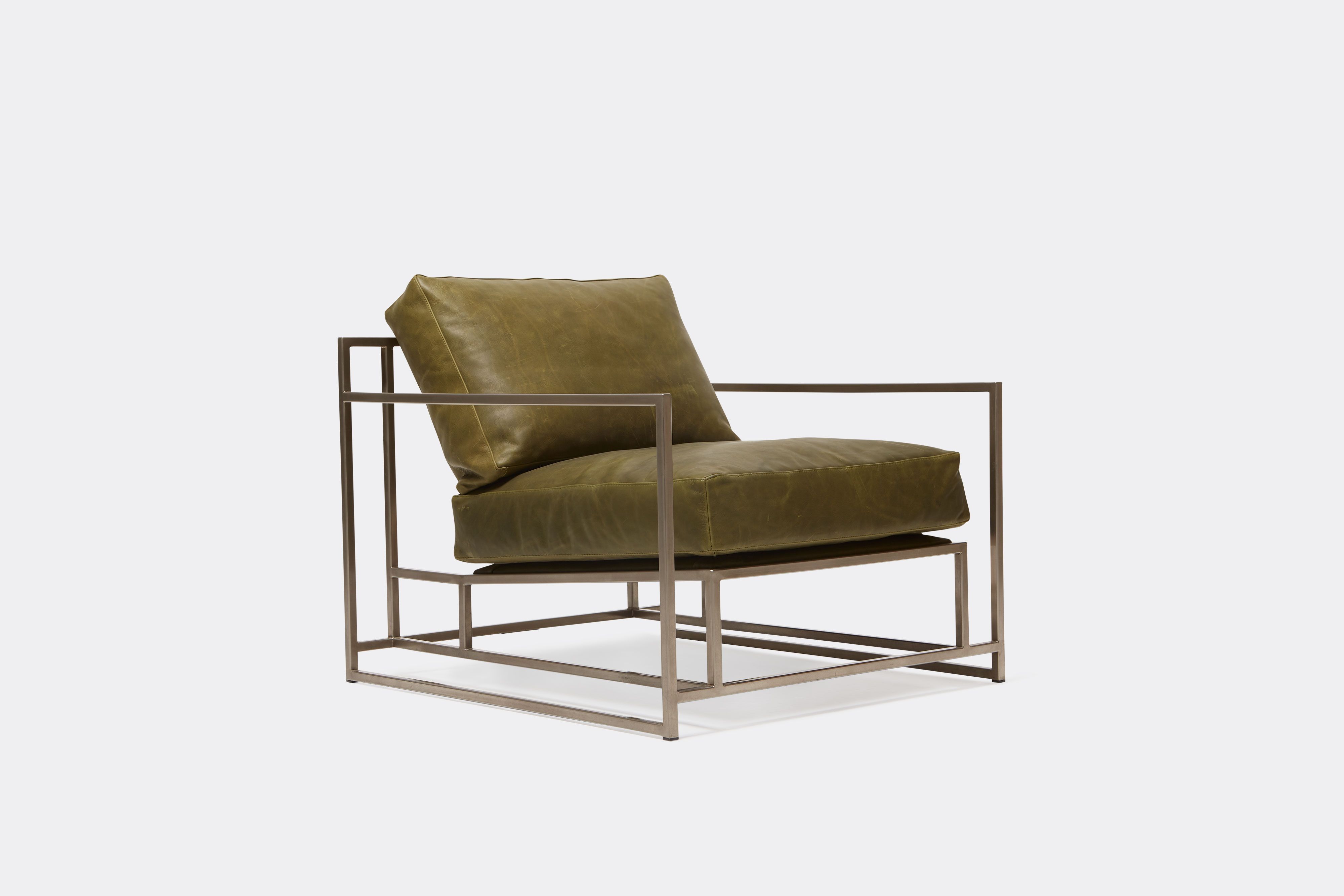 side view of green leather chair with antique nickel frame