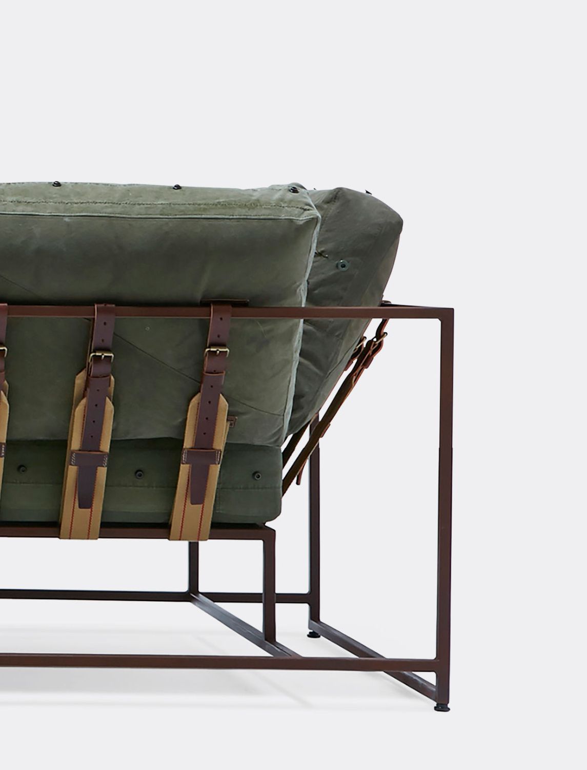 green canvas upholstered sofa with a brown metal frame and supporting belts shown on a white background .