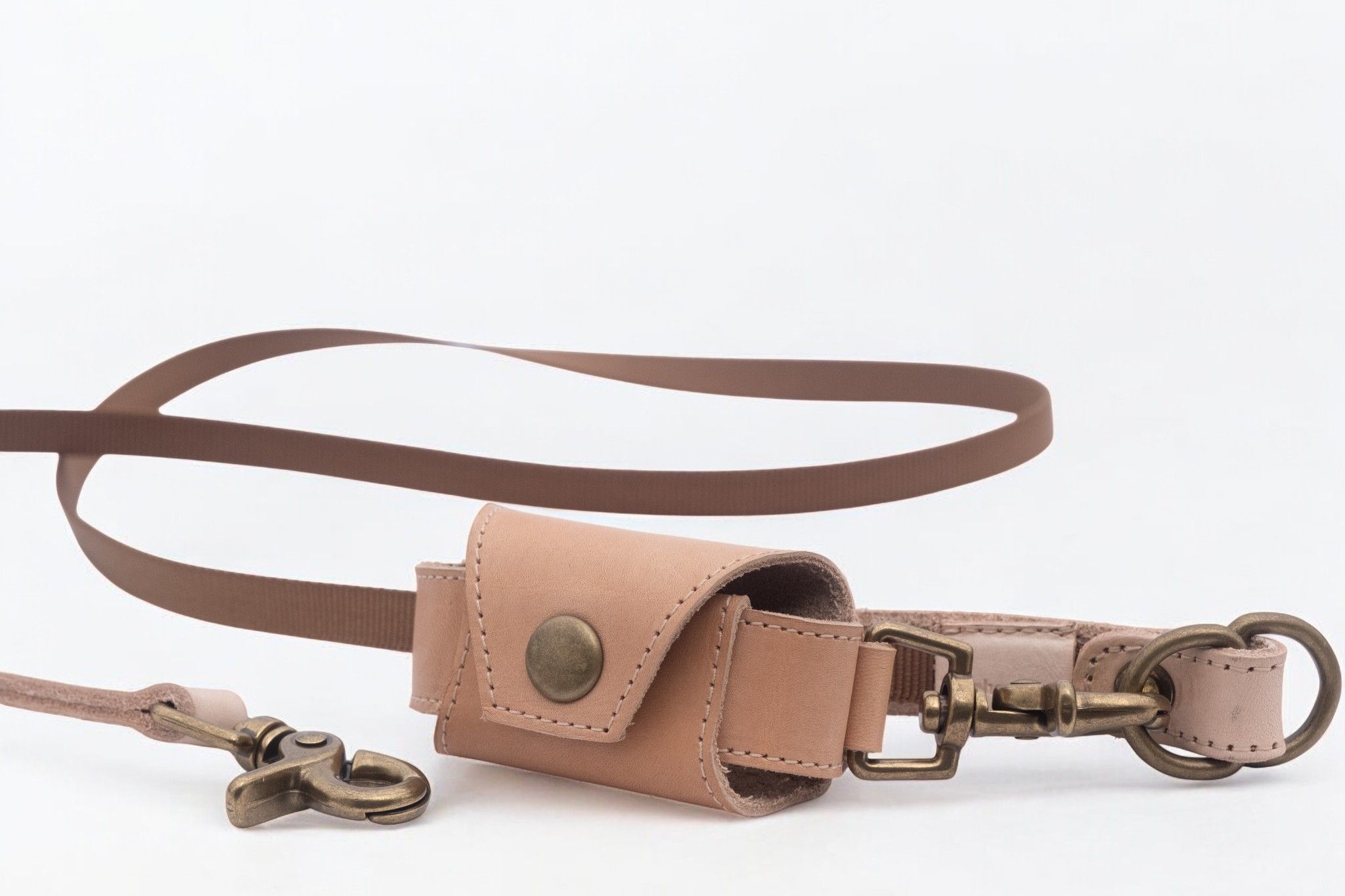 Brown leash with a small light brown leather pouch and brass hardware.