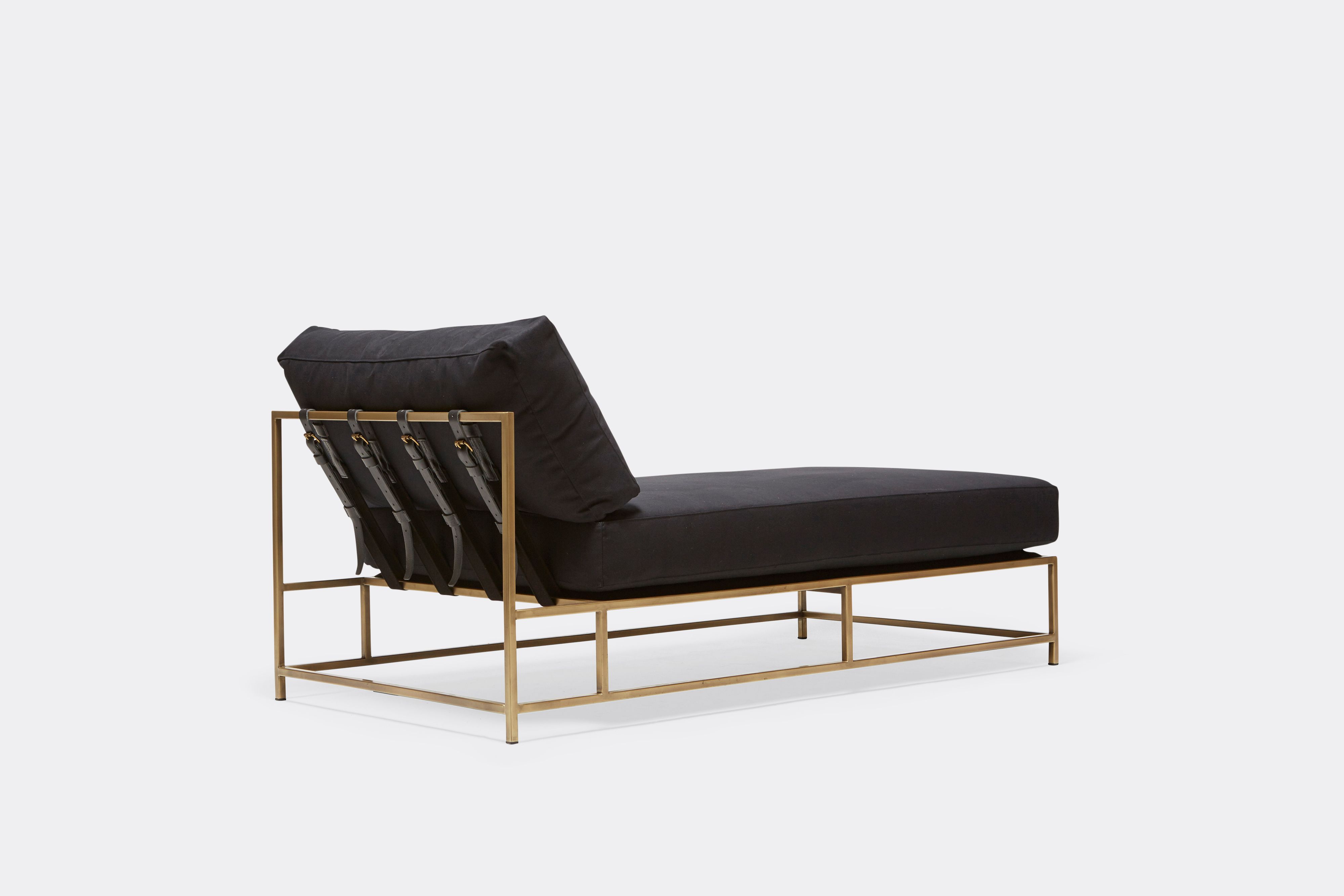 back of Chaise Lounge with black canvas upholstery and black leather belts on antique brass metal frame