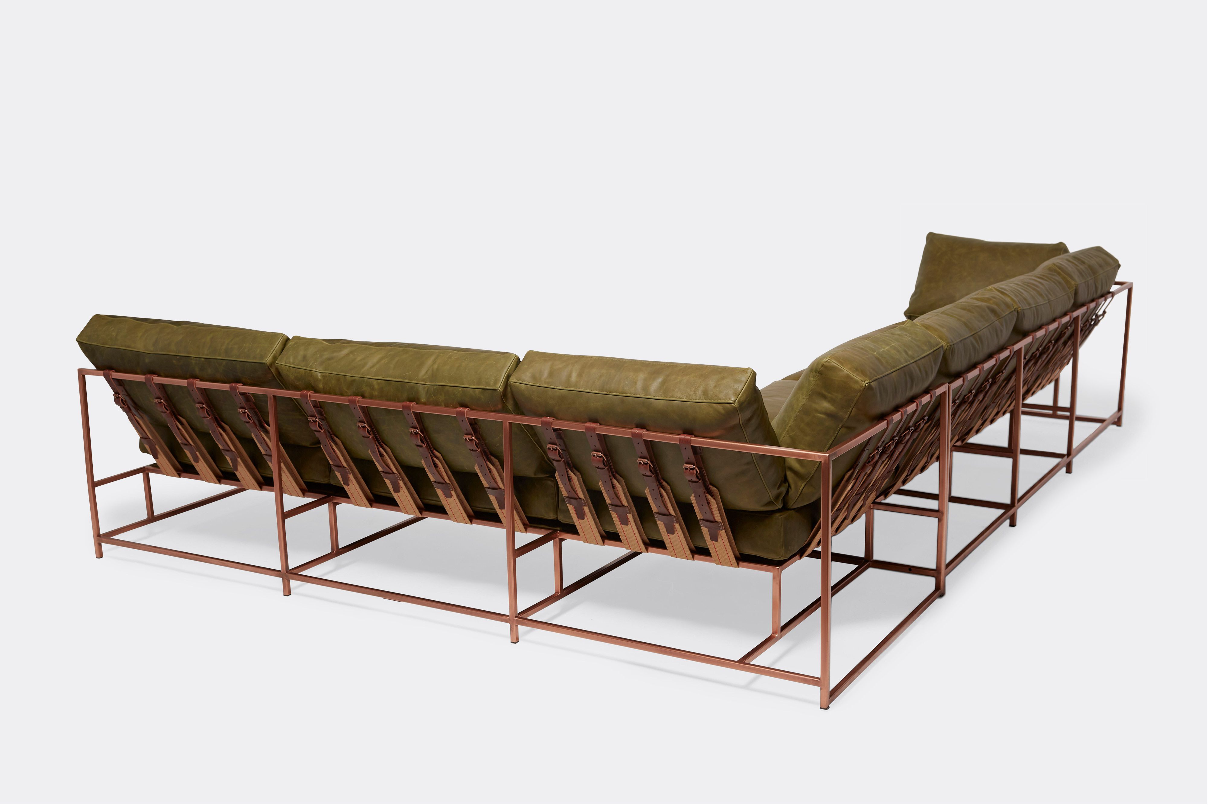back of sectional with green leather upholstery on antique copper metal frame