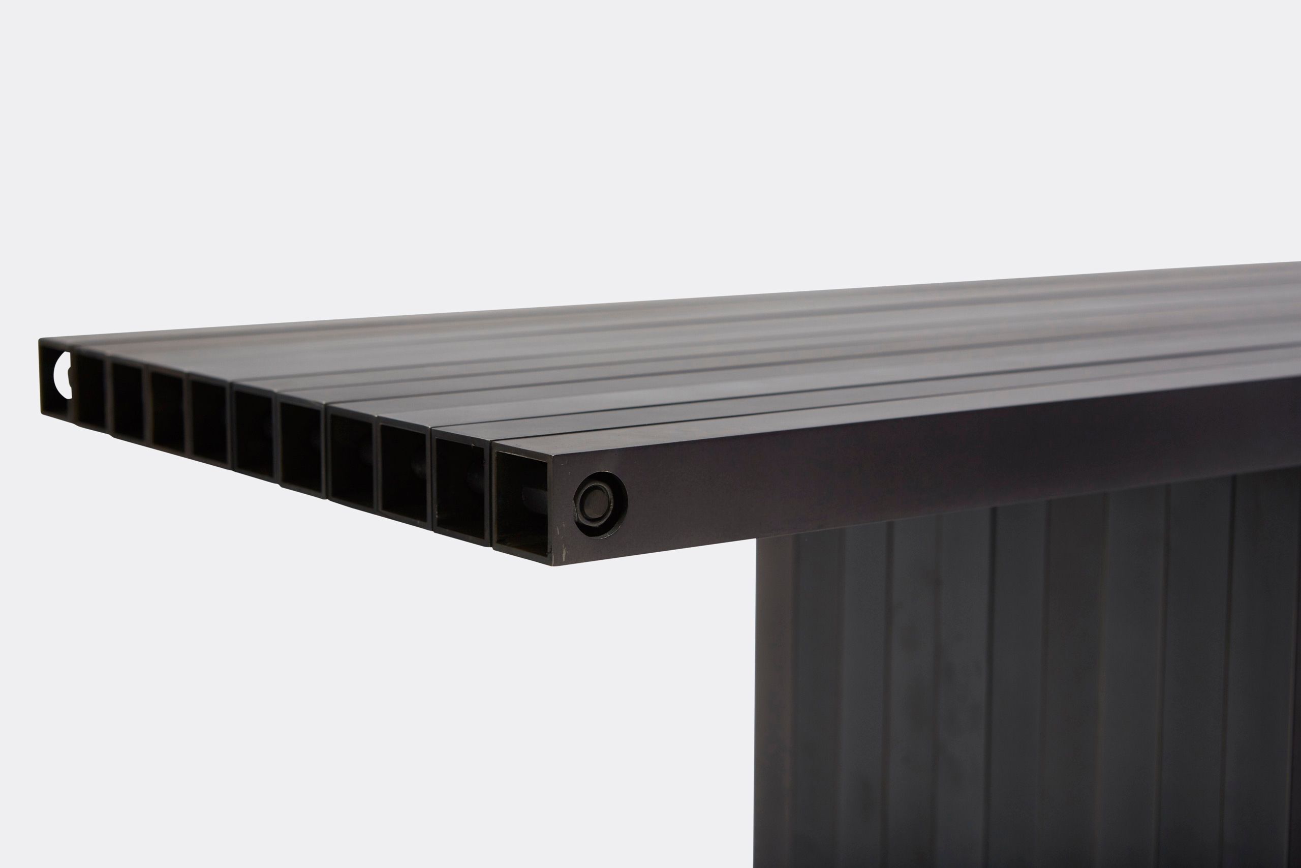 a black aluminum bench on a white background .