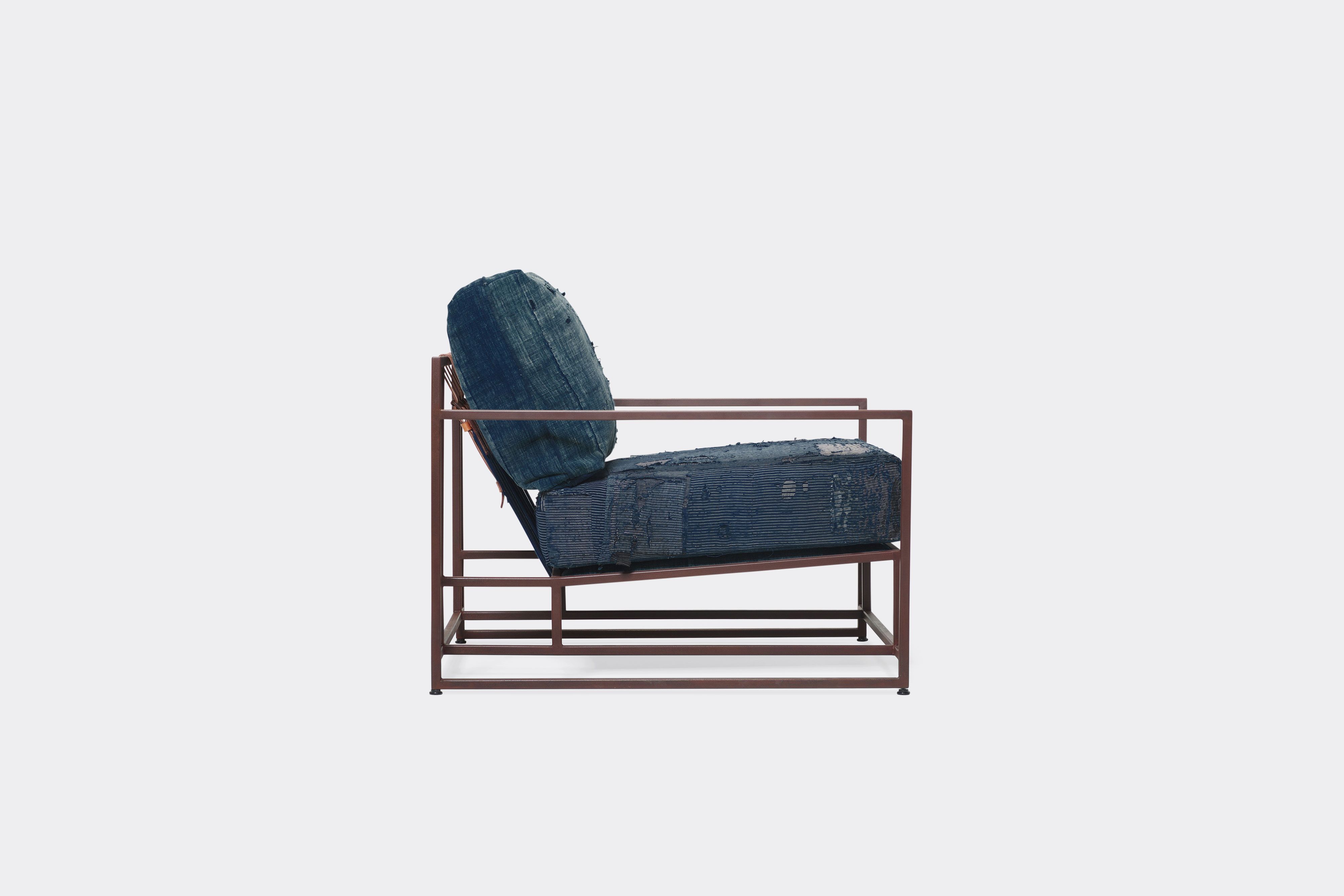 side of armchair with vintage boro upholstery on marbled rust metal frame