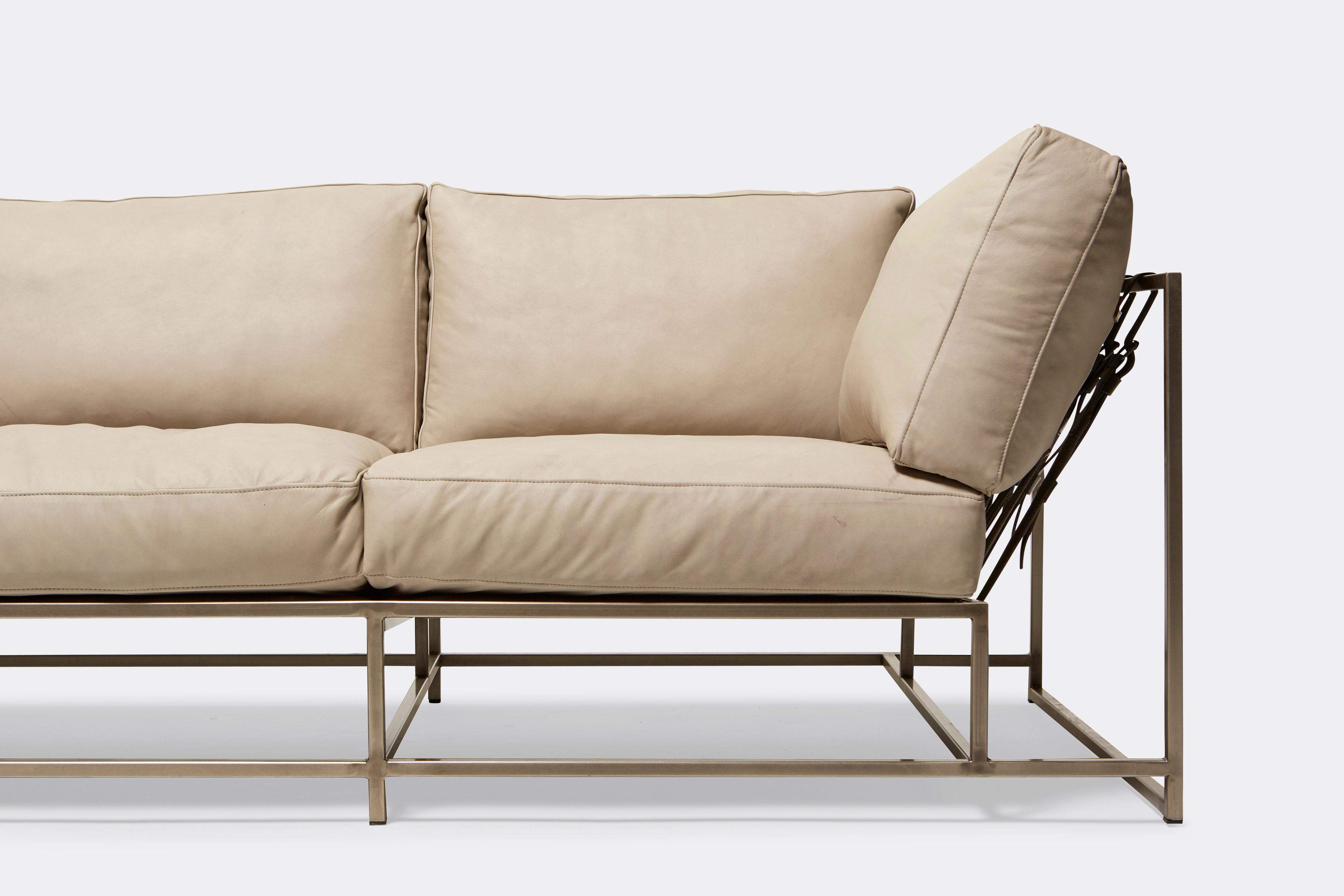 Front of Sofa with cream leather upholstery and antique nickel metal frame