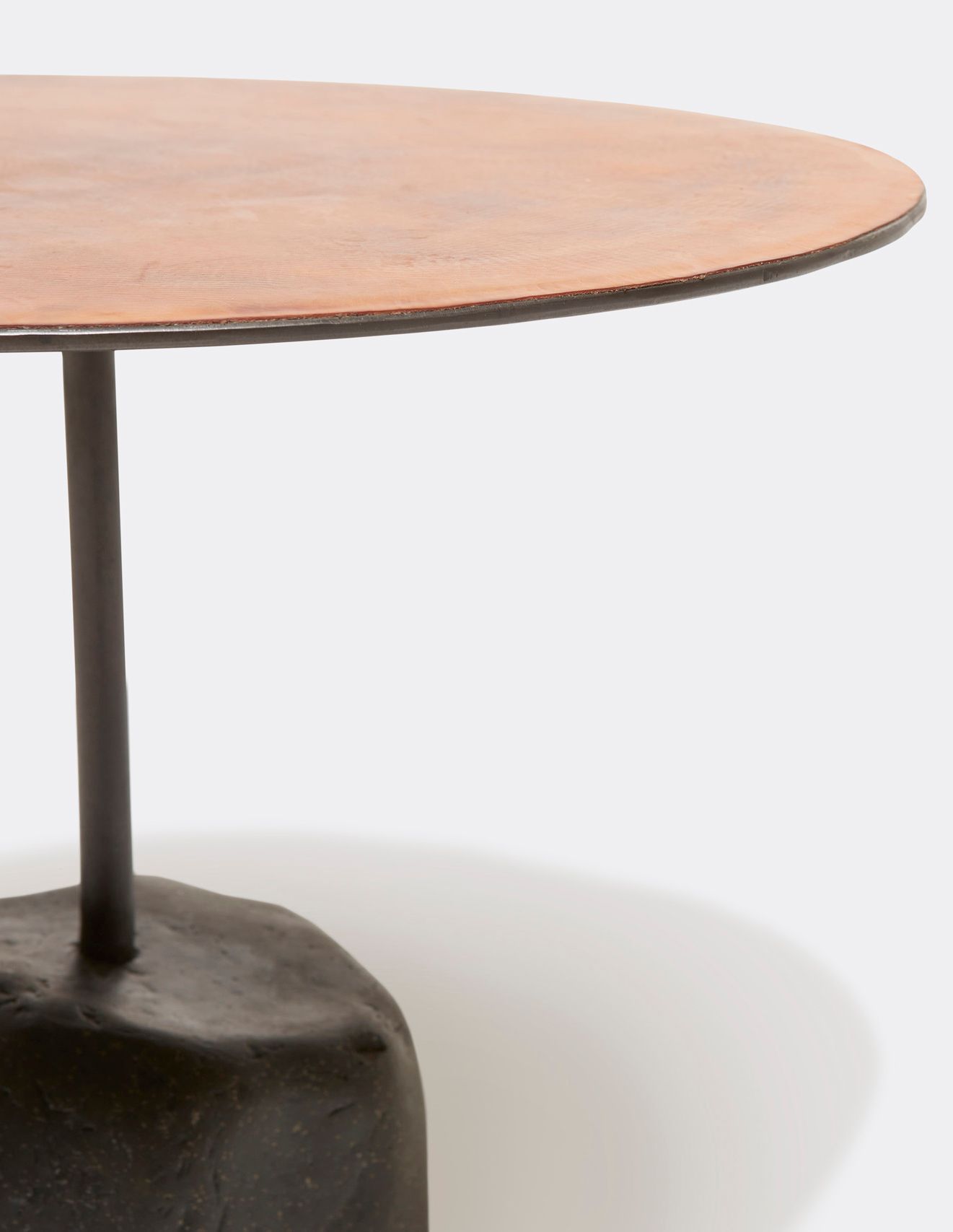 a round table with a brown leather top and a metal frame with a stone base shown on a white background .