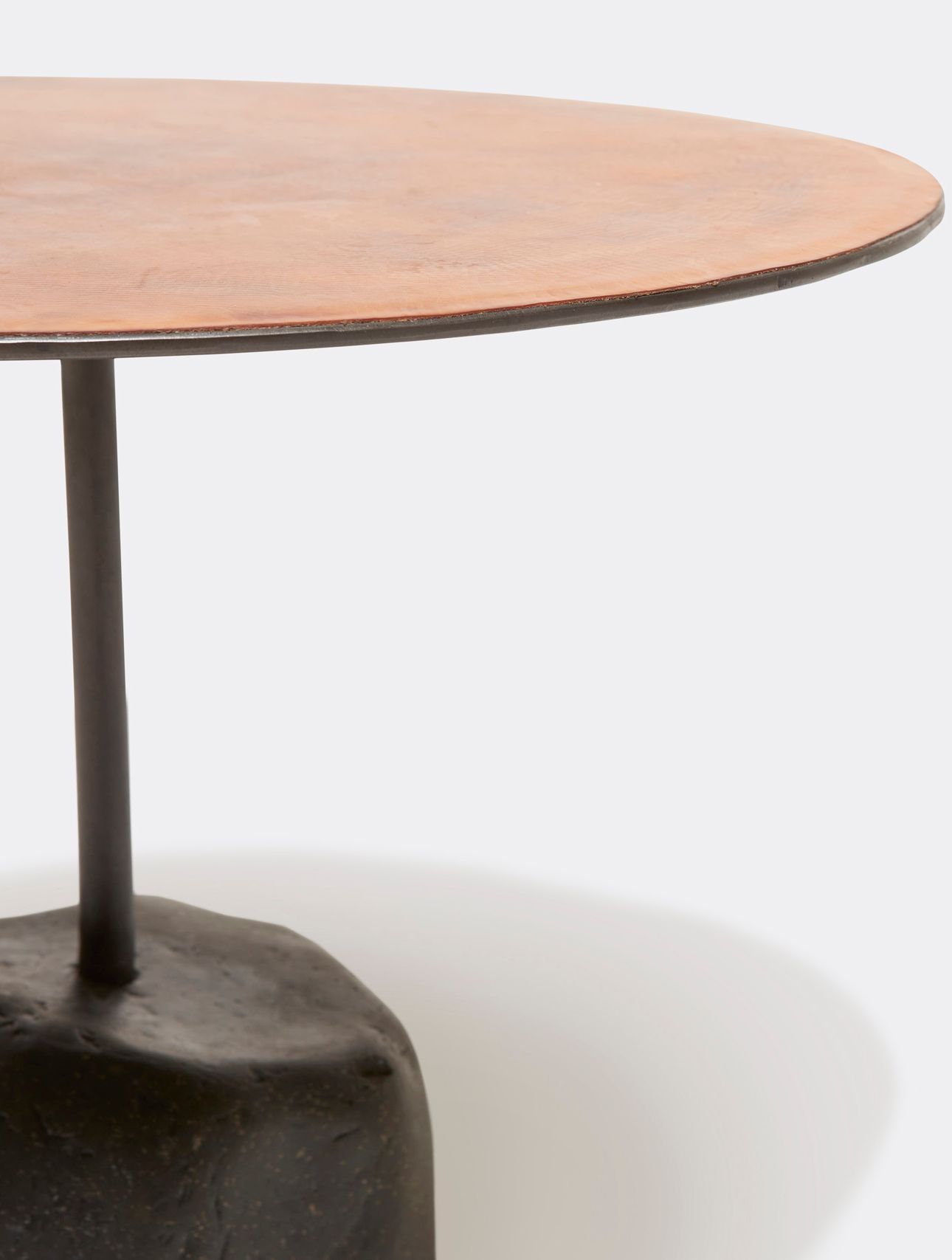 a round table with a brown leather top and a metal steel frame and stone base shown on a white background .