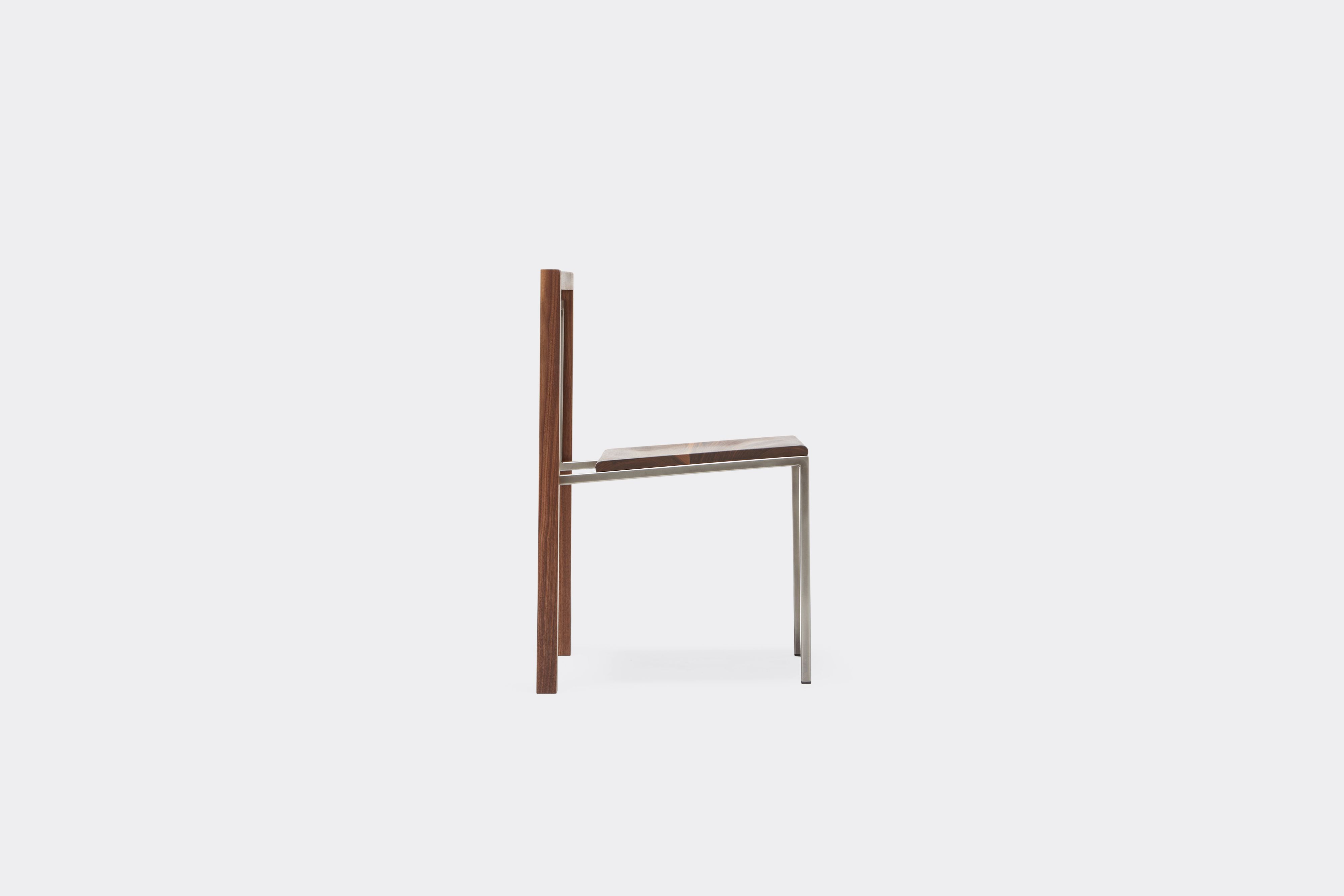 Side view of walnut and antique nickel dining chair