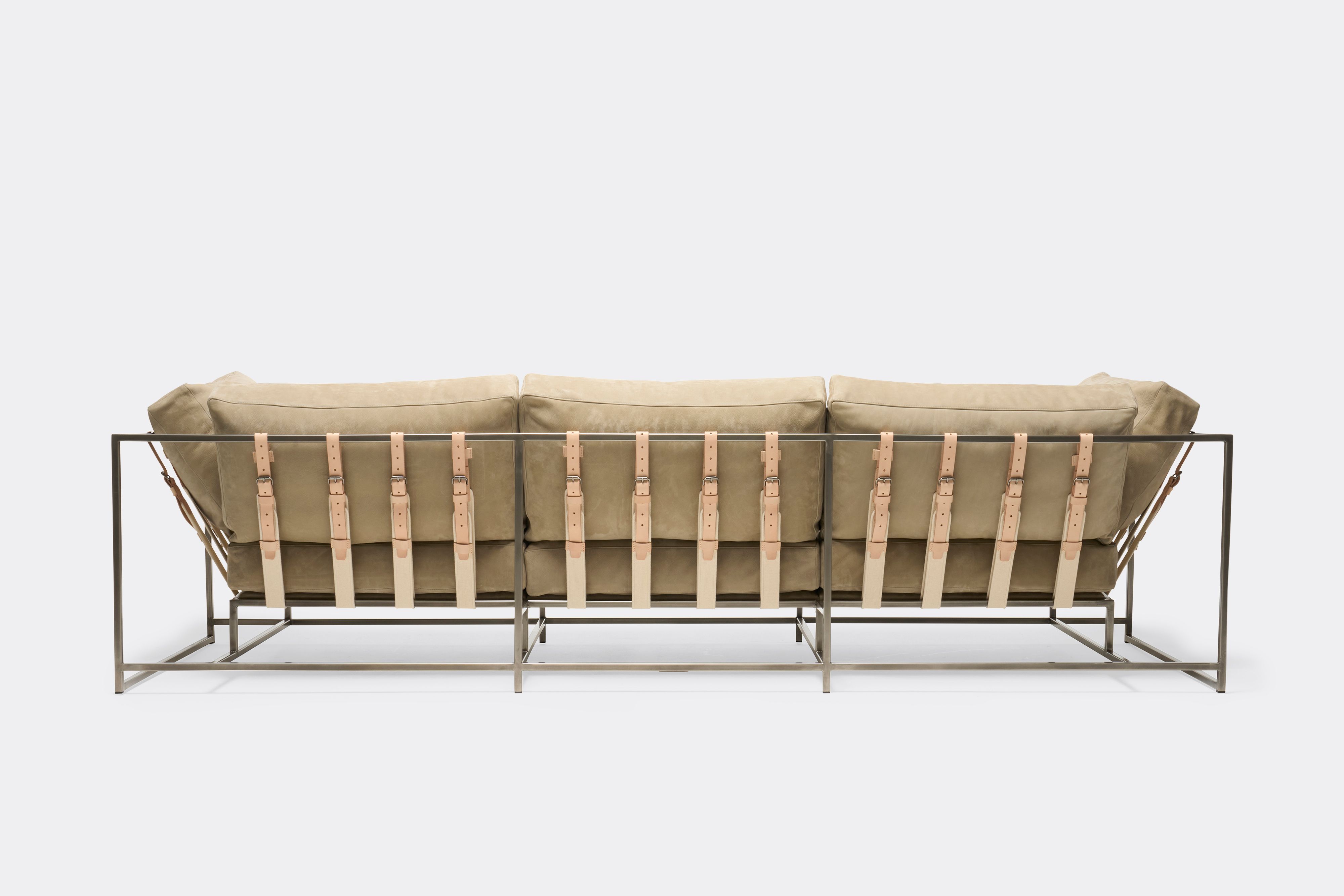 back of Sofa with tan leather upholstery and veg tan leather belts on antique nickel metal frame