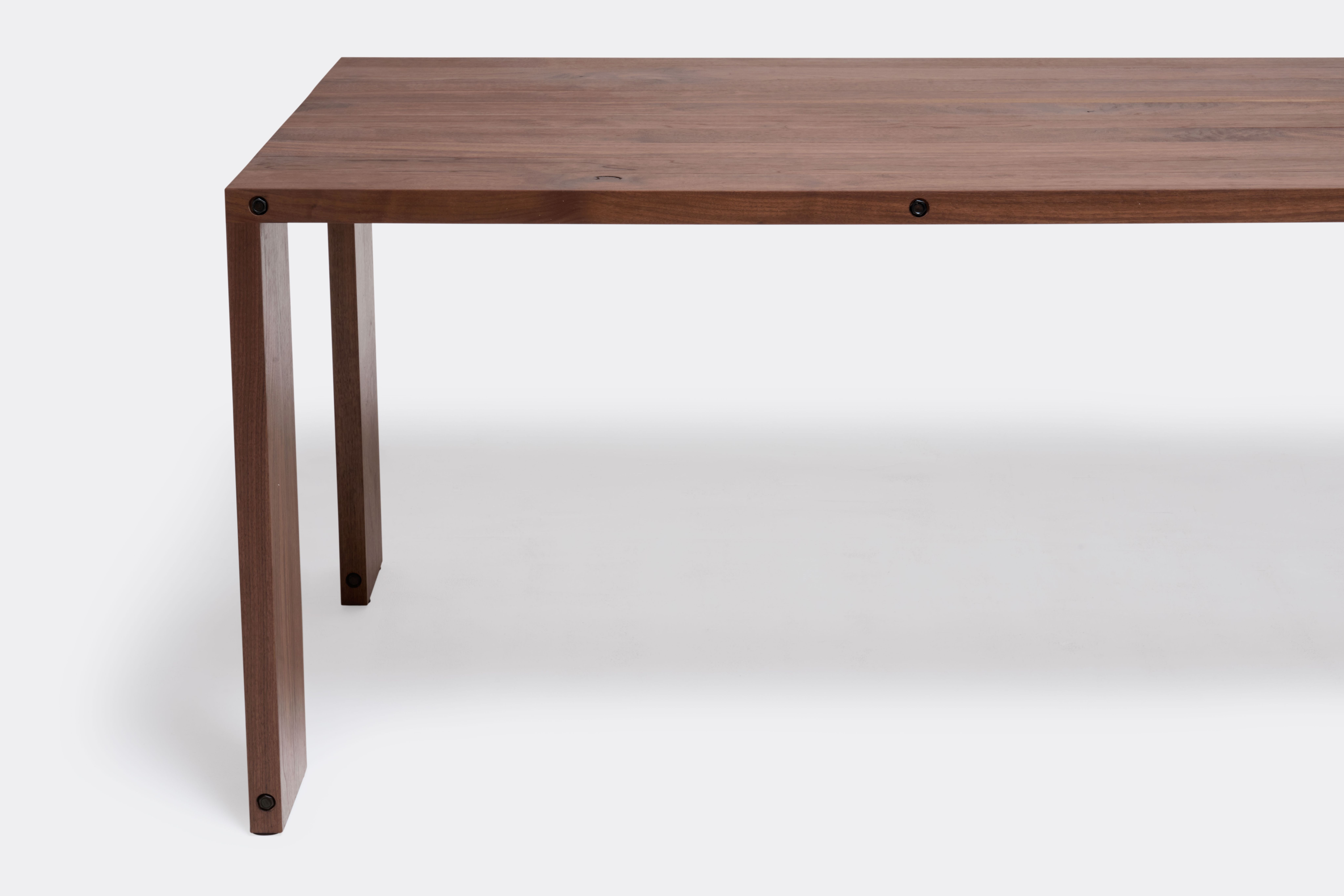 a long walnut wooden table on a white background .