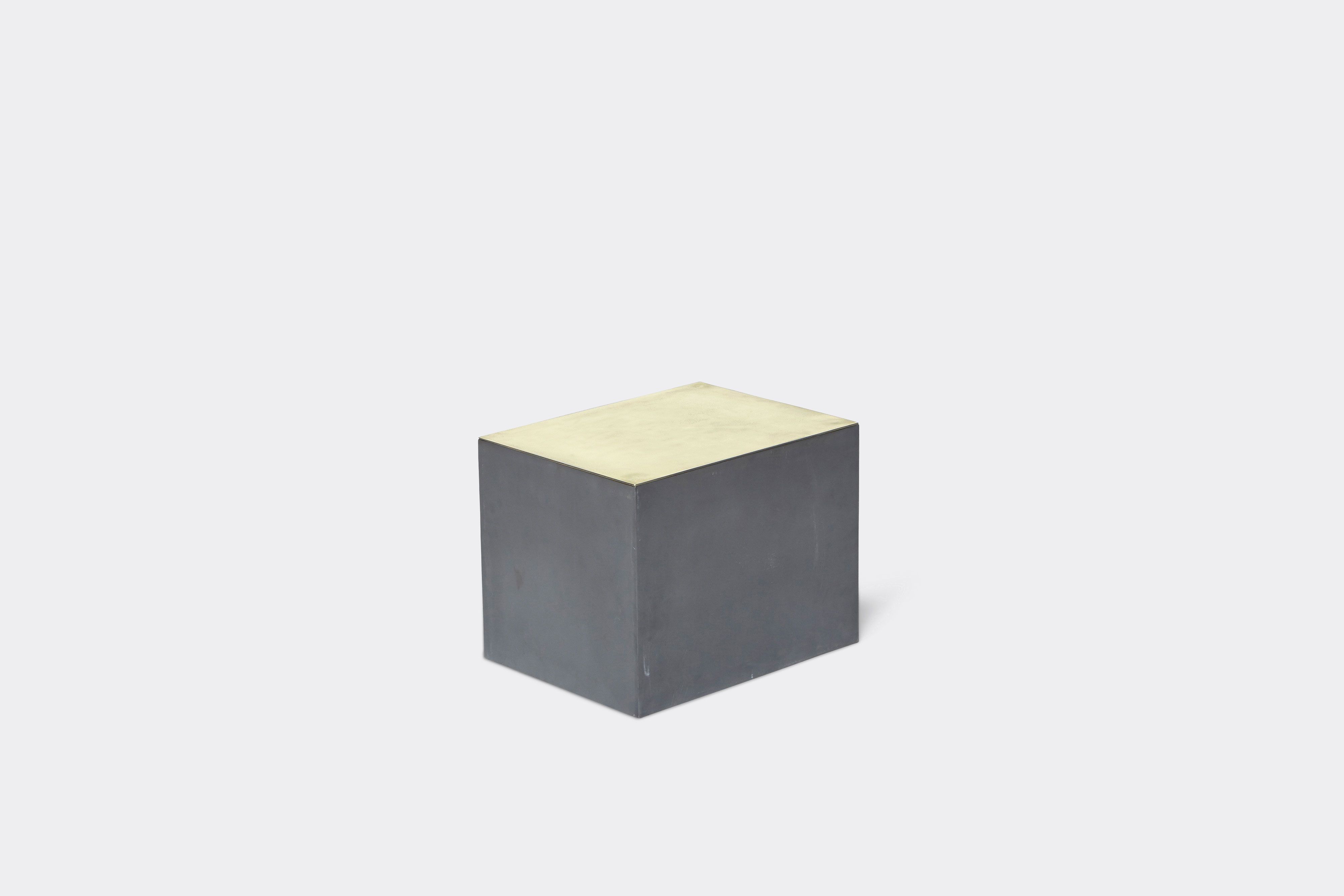 side of block table made with tarnished brass and black metal frame