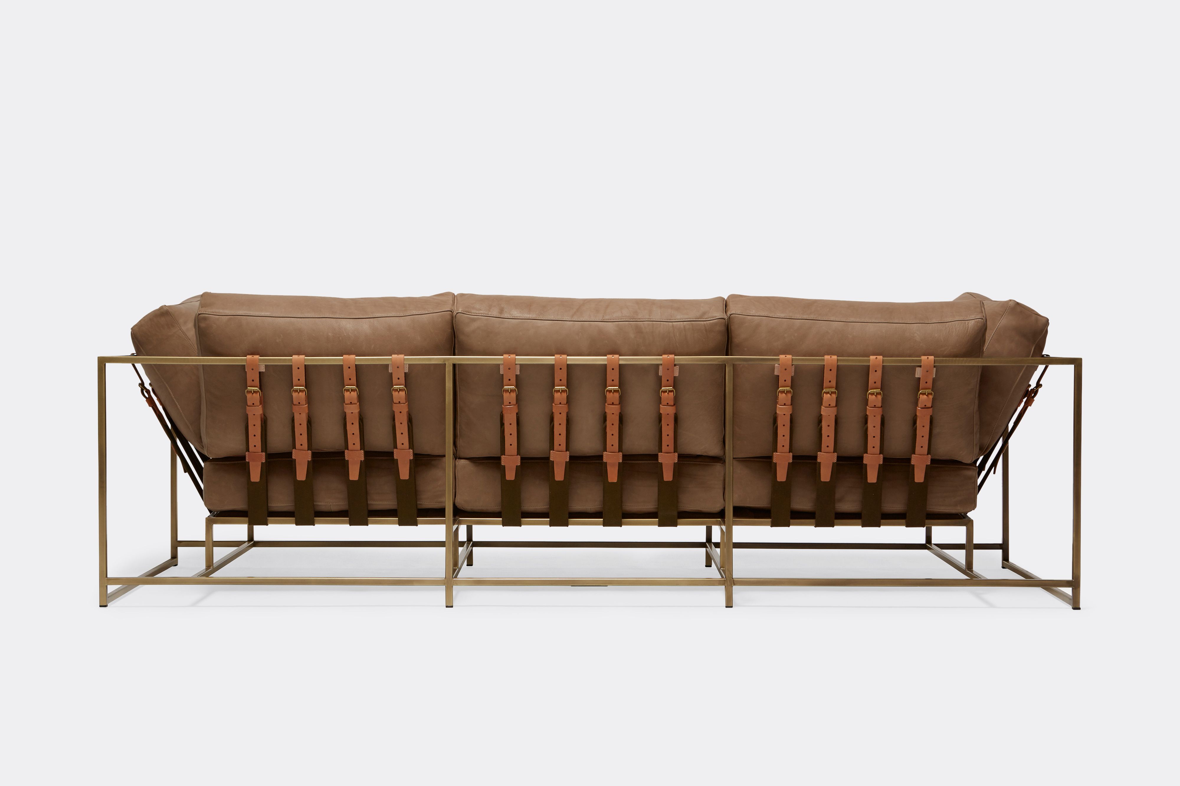 back of Sofa with brown leather upholstery and brown leather belts on antique brass metal frame