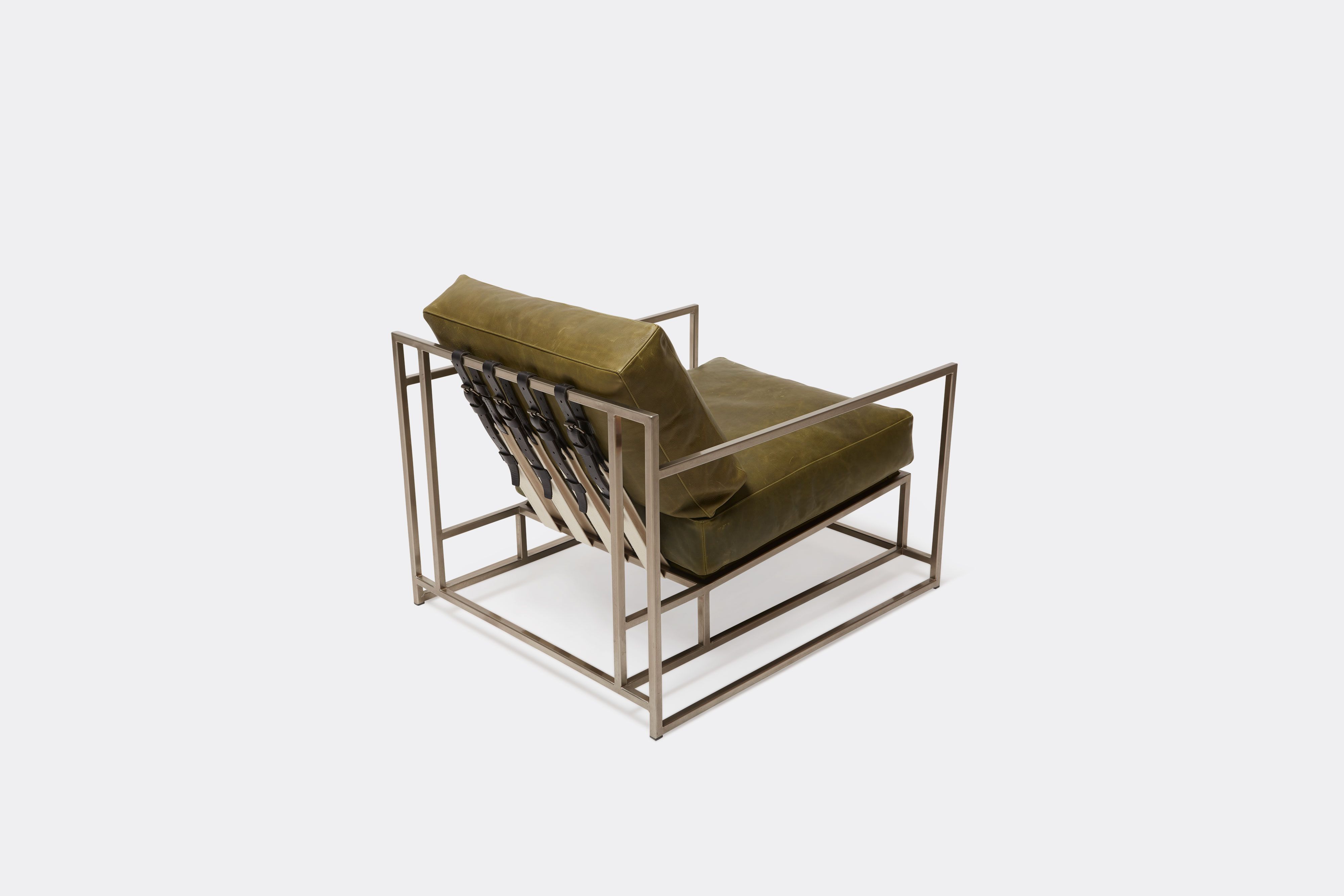 top view of green leather chair with antique nickel frame and leather belts