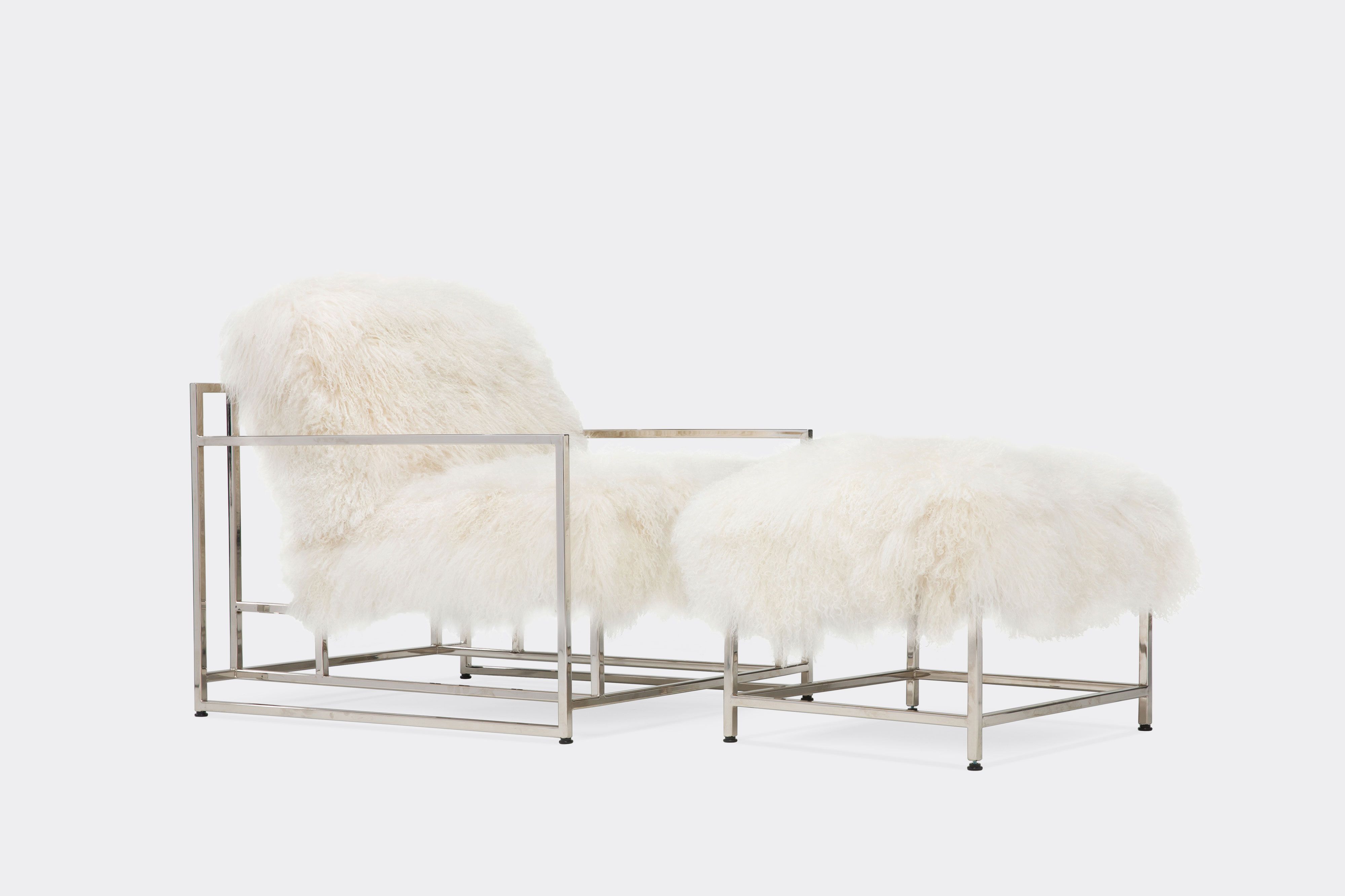 a white sheepskin armchair with black supporting belts on the back is sitting on a white surface .