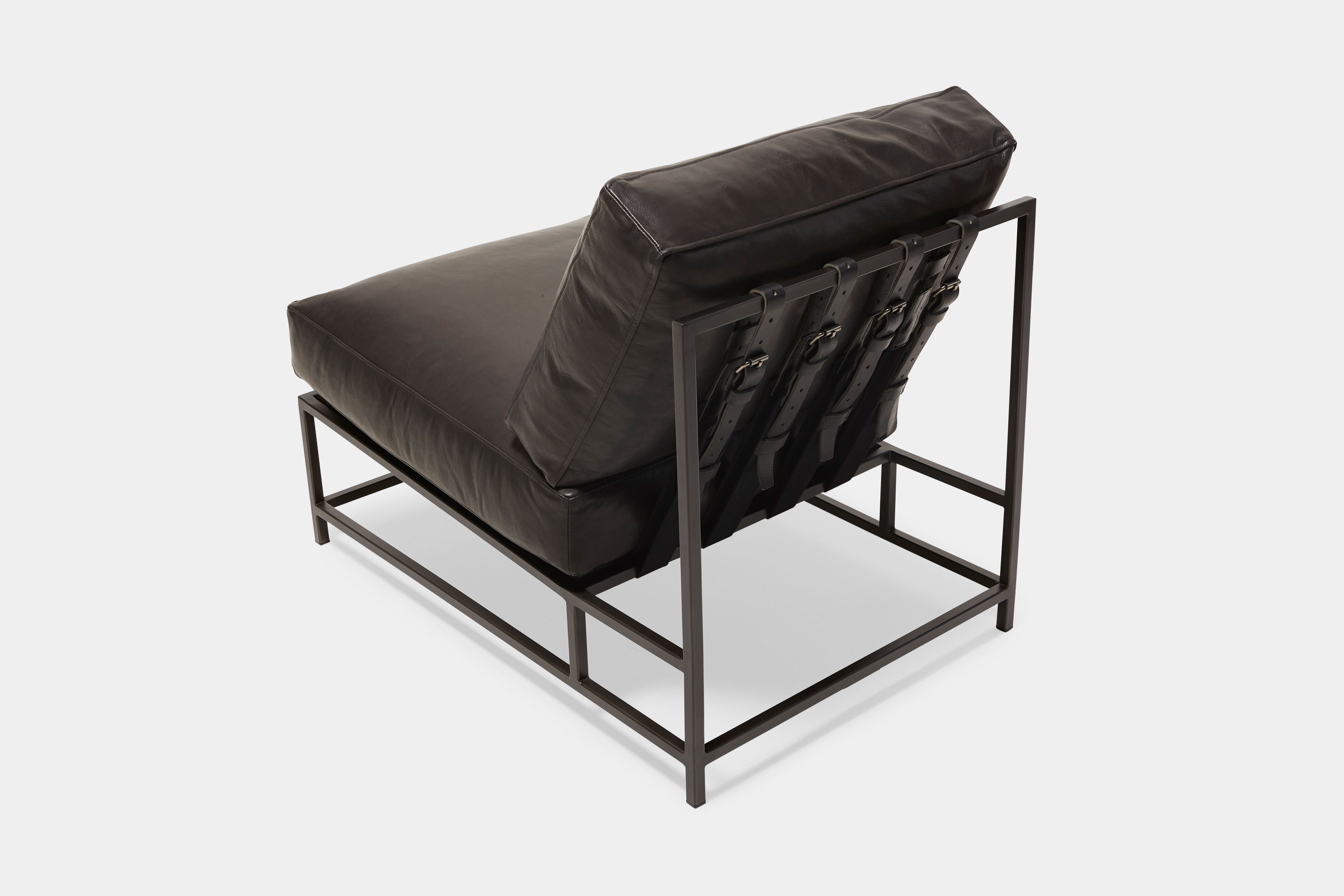 overhead view of lounge chair with black leather upholstery and black leather belts on black metal frame
