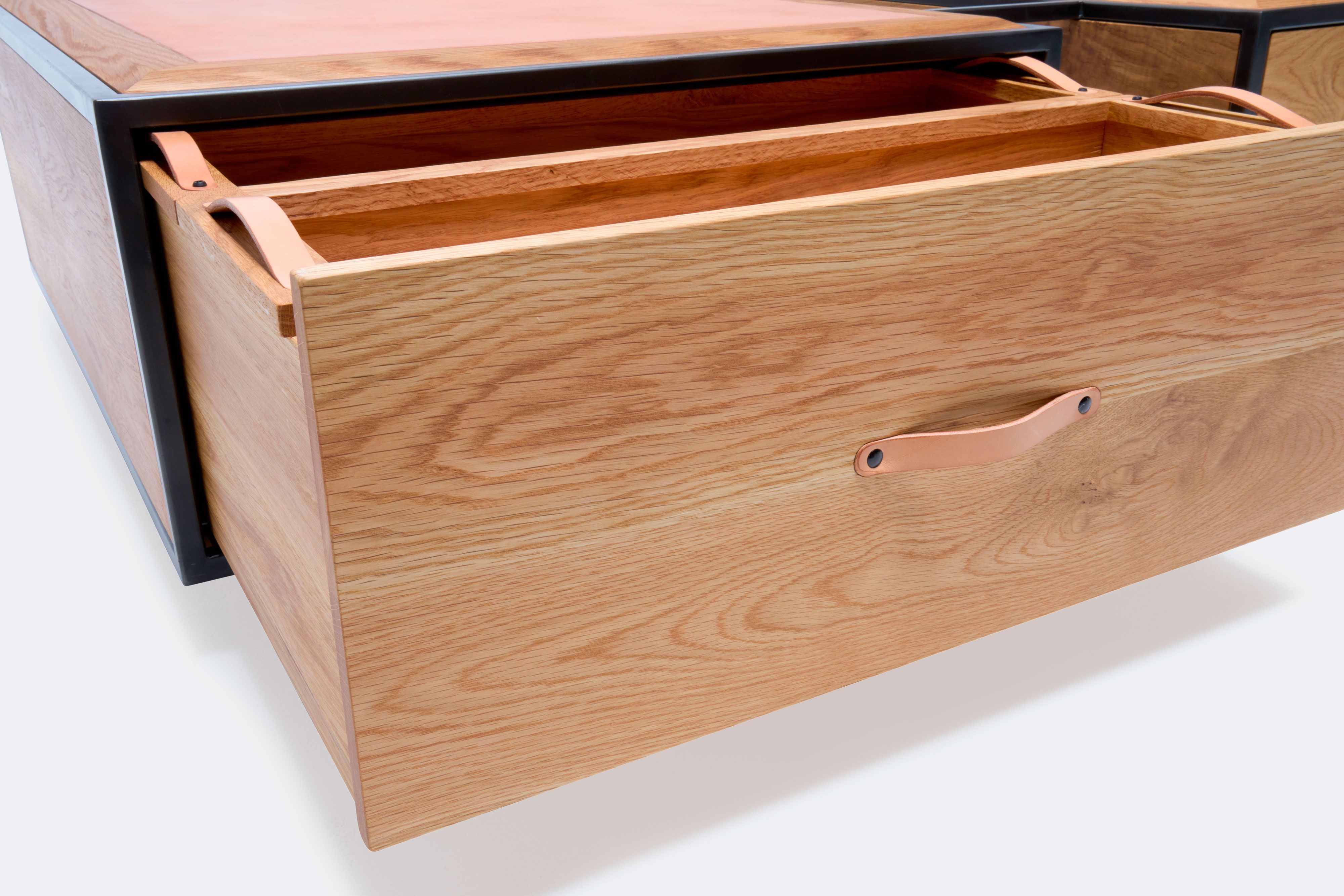 detail of double display coffee table with white oak wood, blackened steel metal and leather top