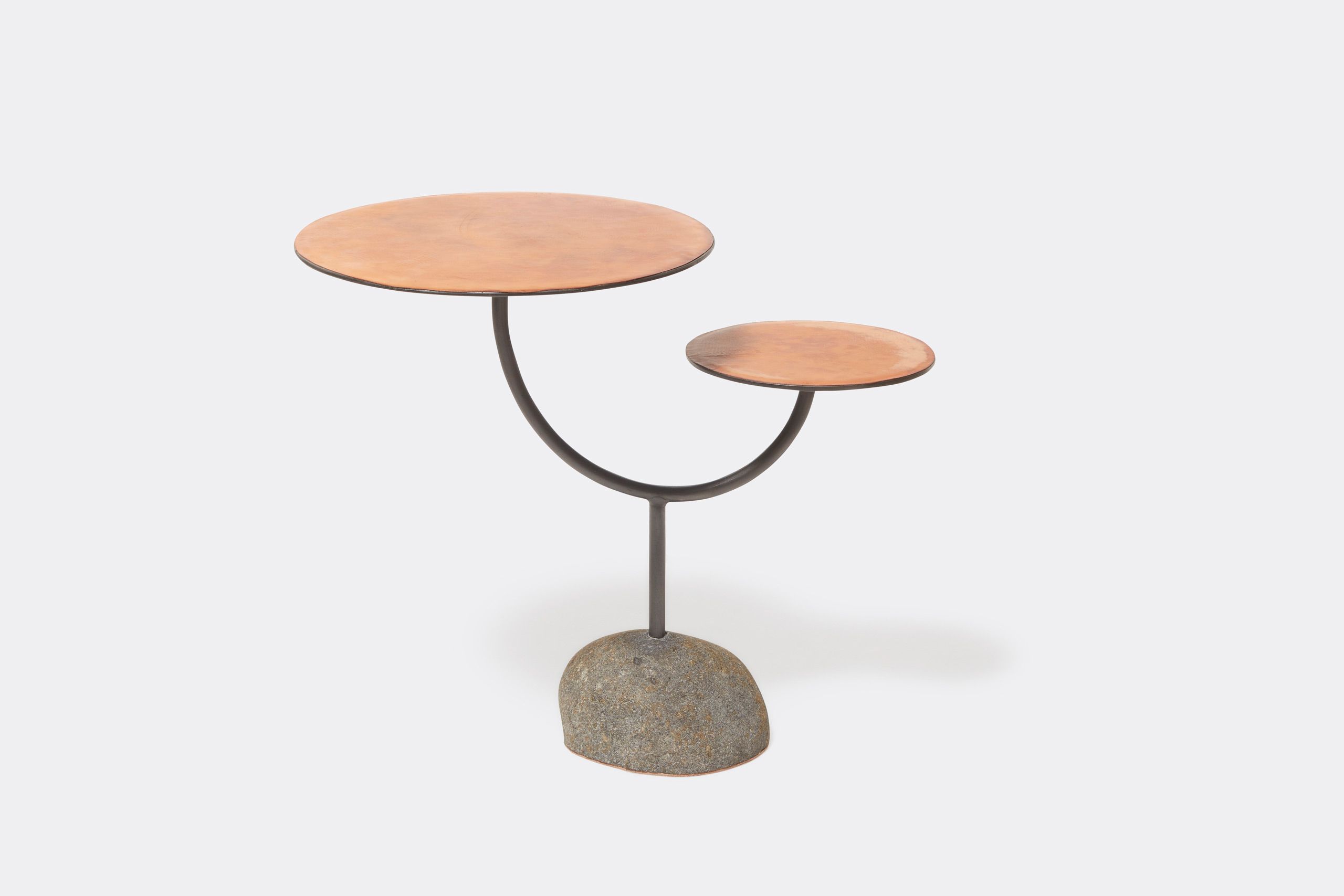 a round table with a brown leather top and a metal steel frame and stone base shown on a white background .