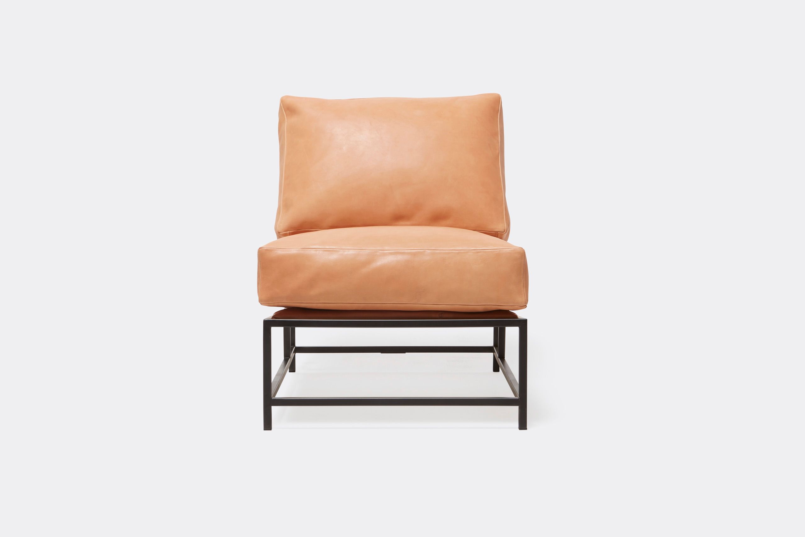 a tan leather chair with a metal frame and leather and webbing supporting belts shown on a white background .