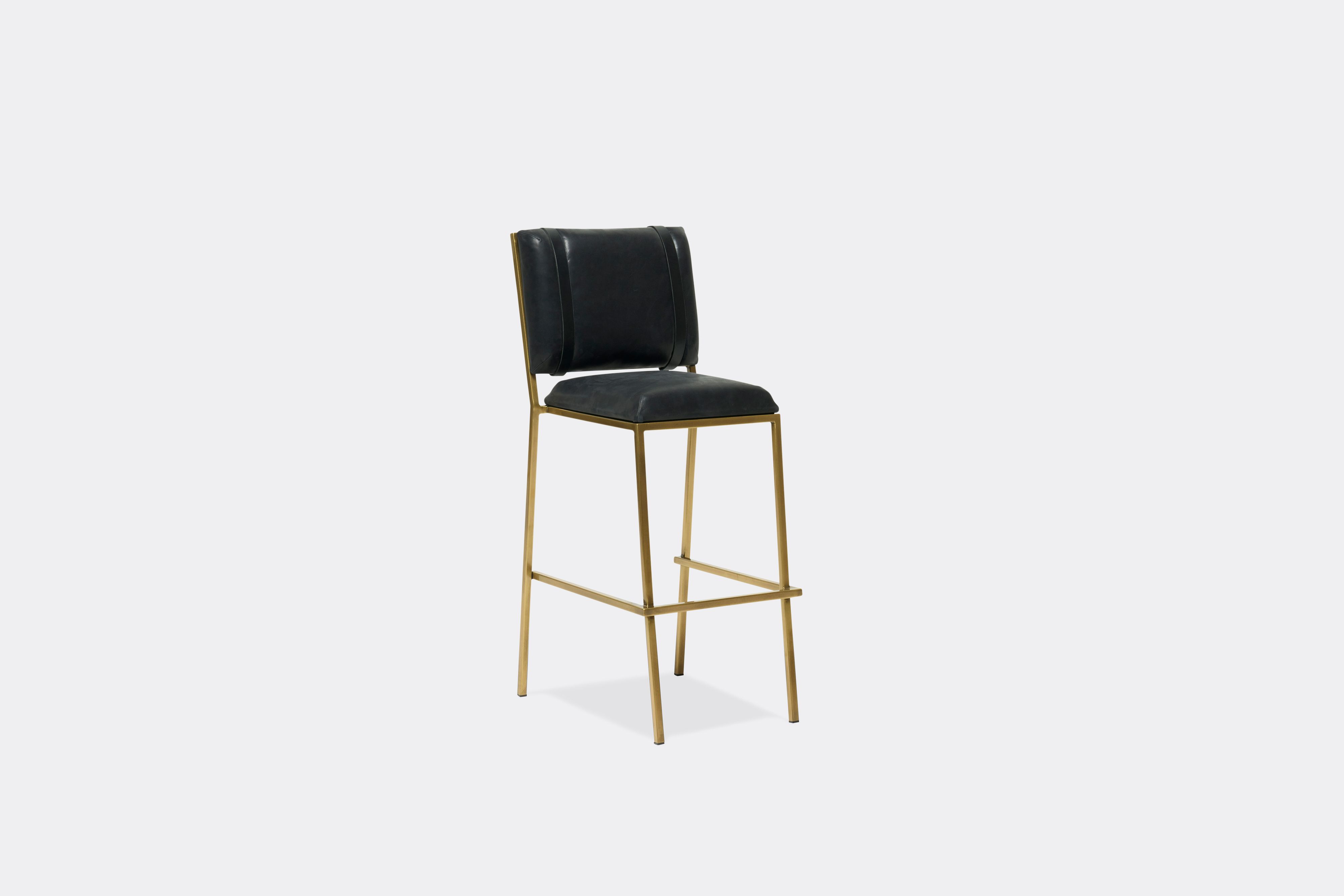 Front view of black leather barstool with antique brass metal frame