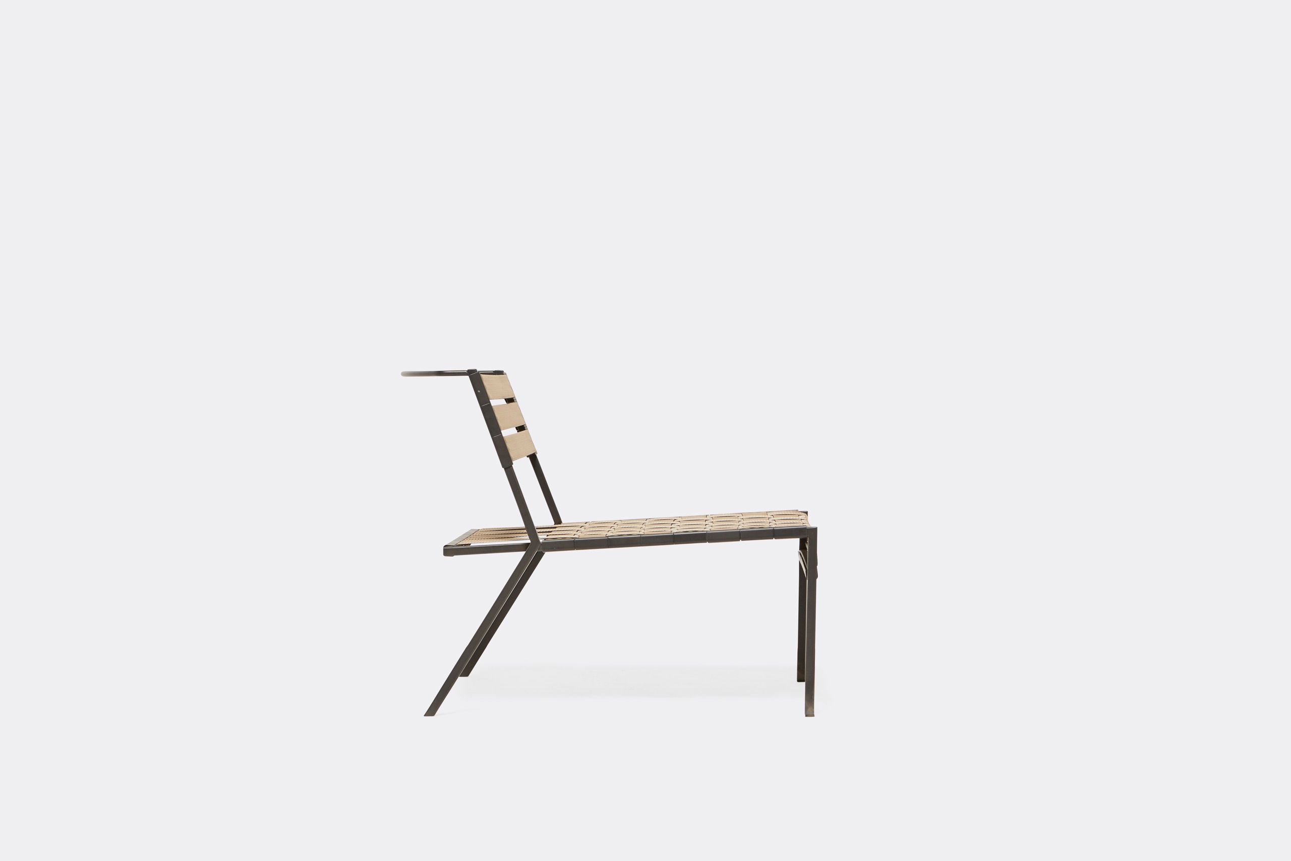 An outdoor steel chair with black metal finish and interwoven tan webbing on a light background