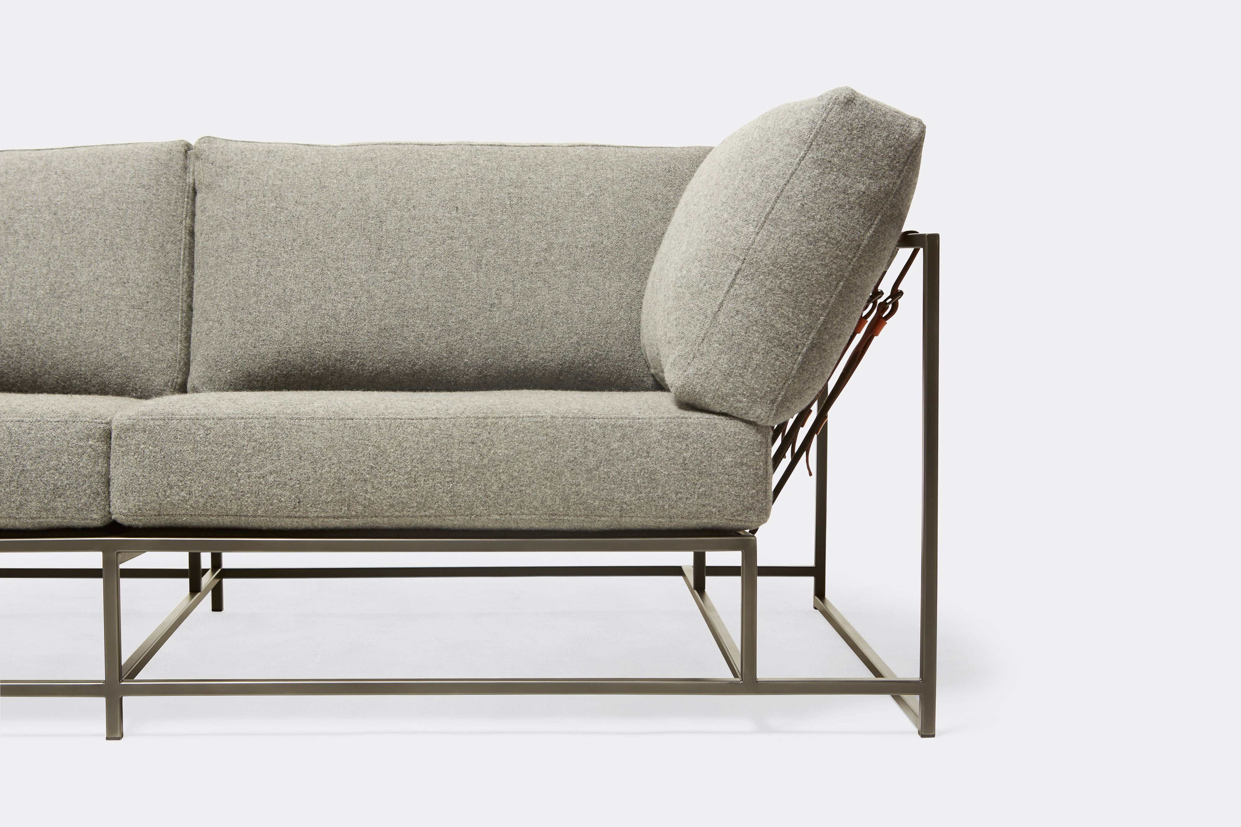 Front of two seat sofa with grey wool upholstery black metal frame