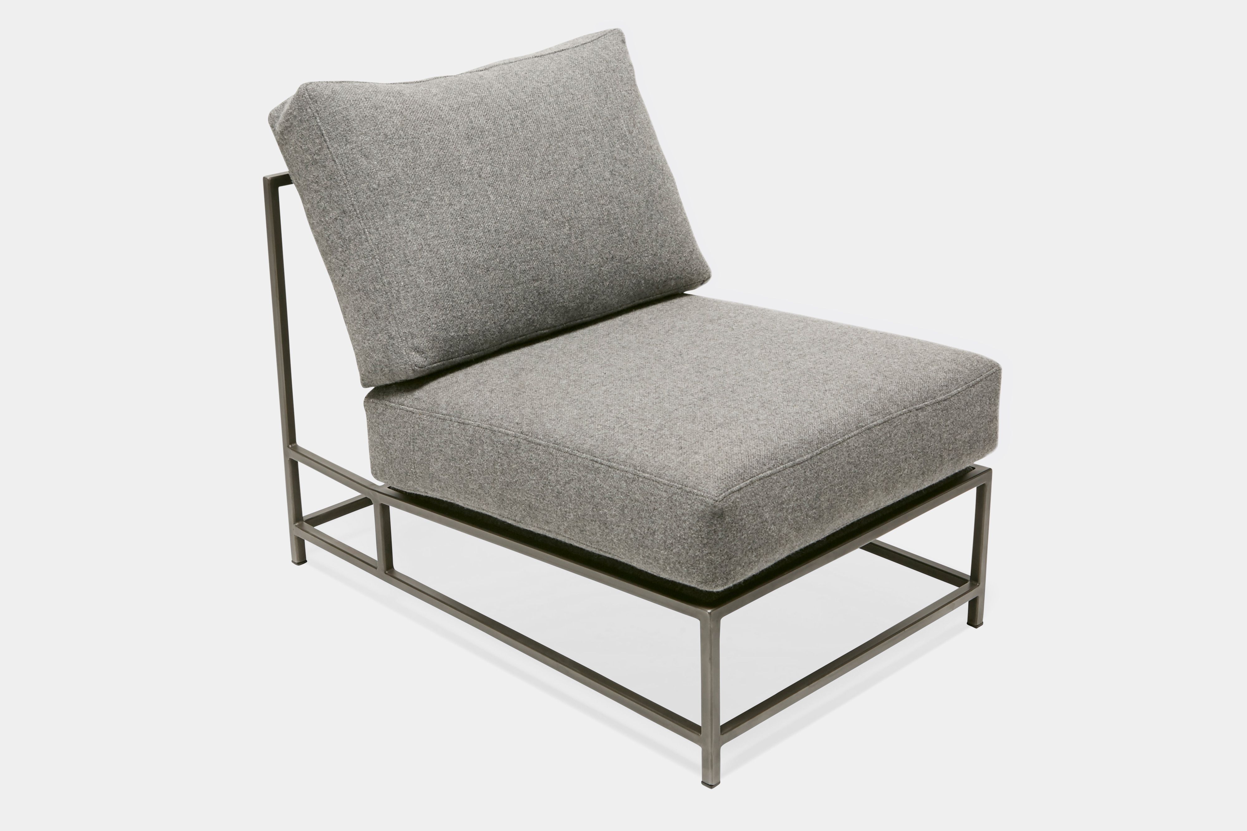 Front view of lounge chair with grey wool upholstery and antique nickel metal frame