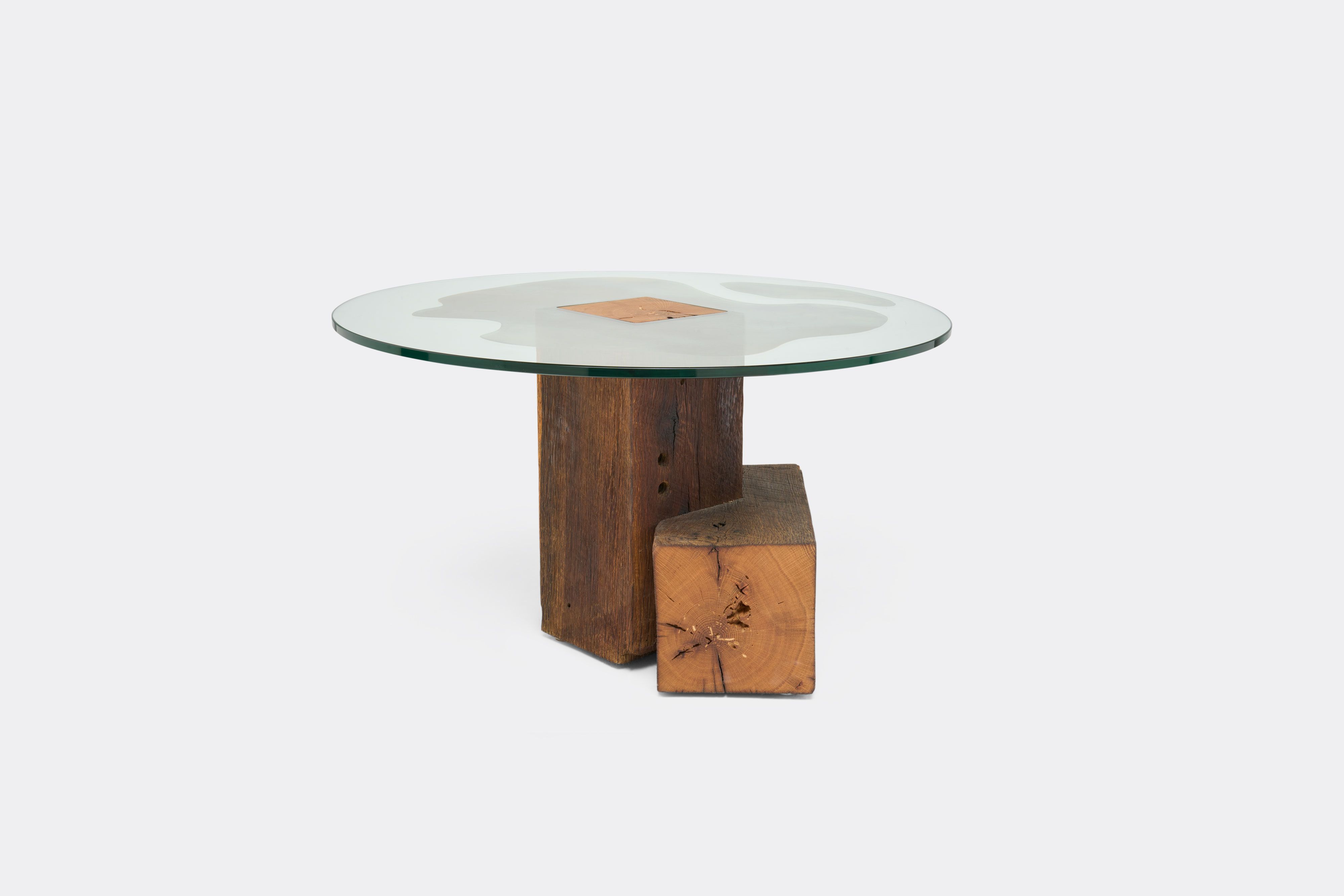 a round table with a glass top and a wooden base on a white background .