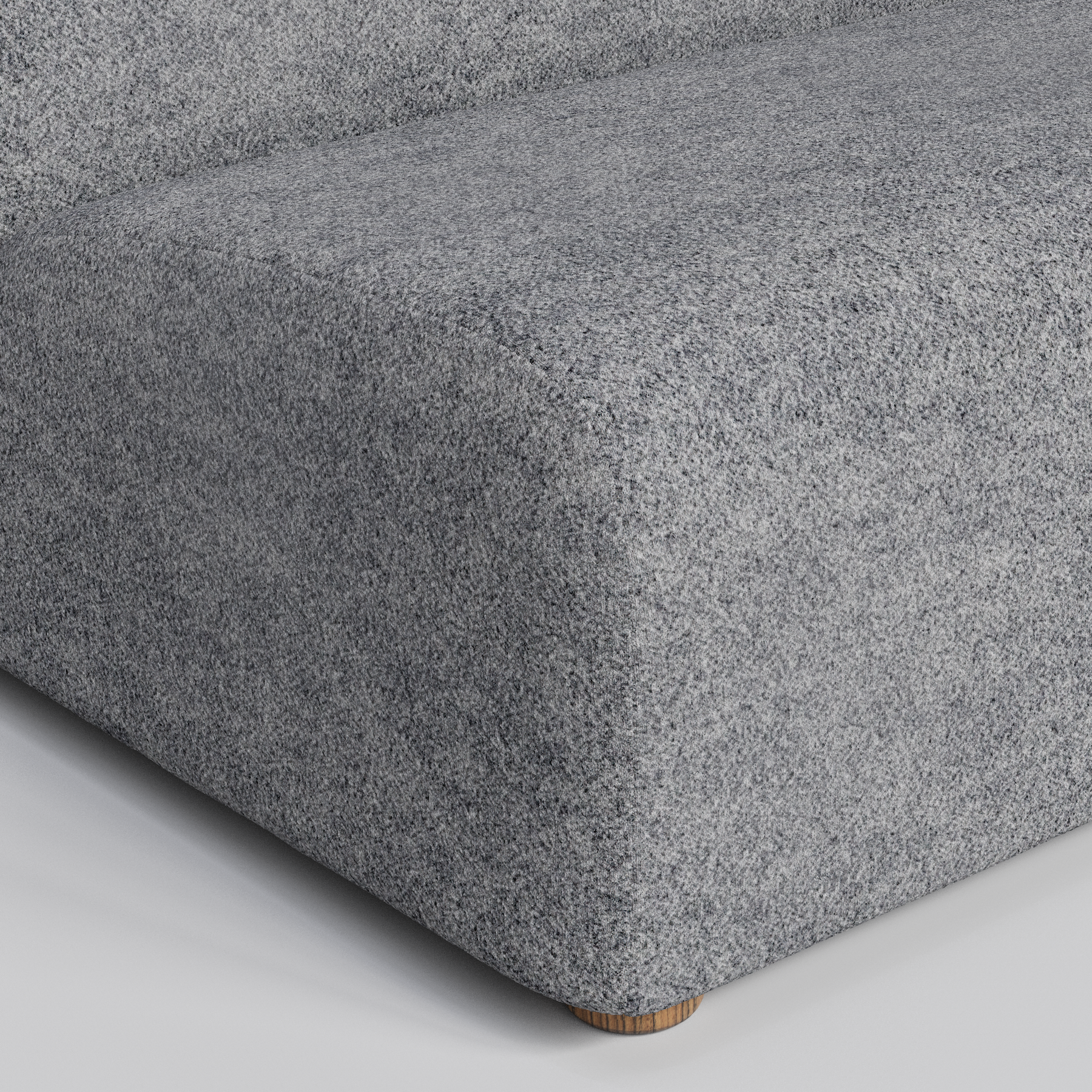 Gray textured furniture with a small wooden leg.