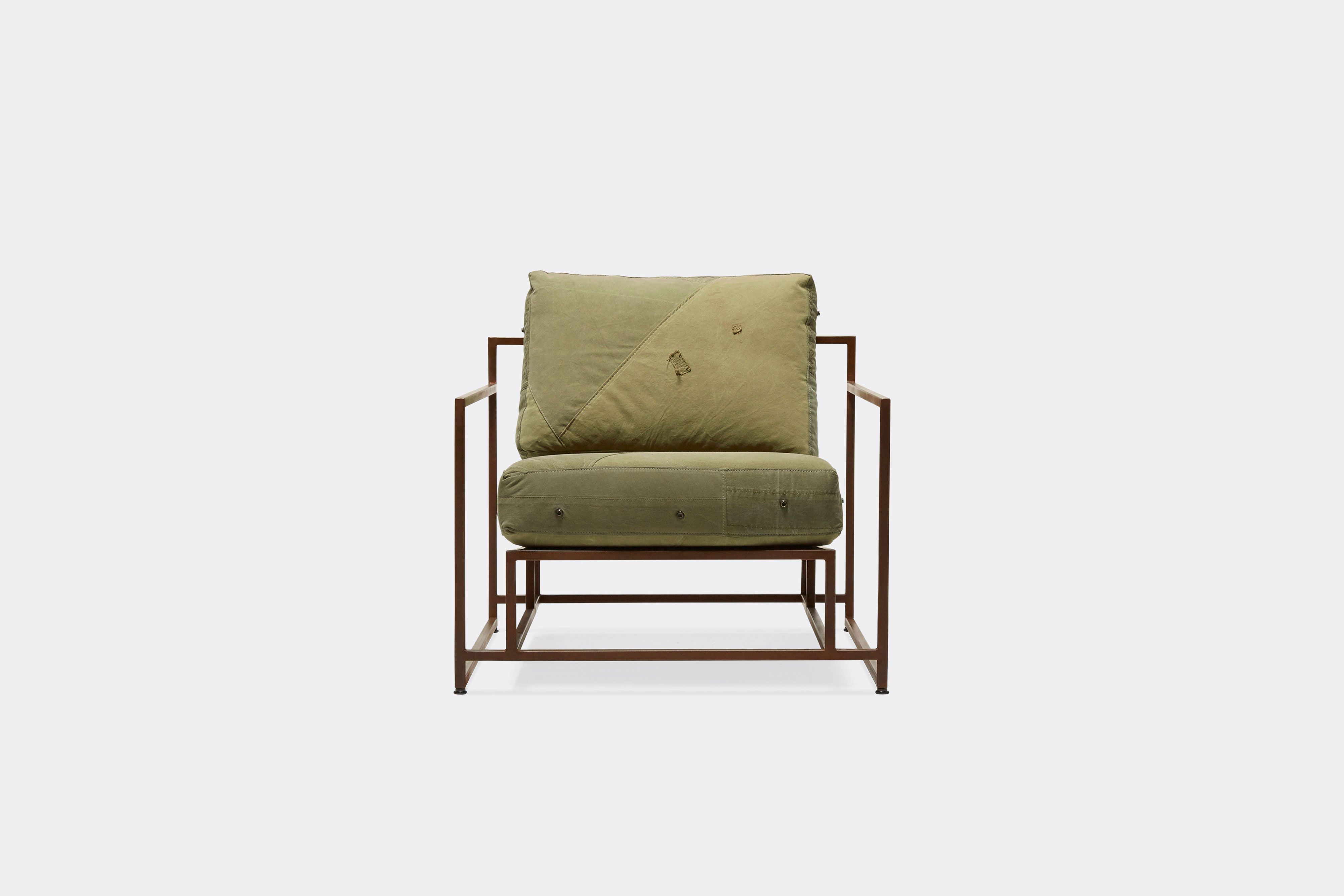 front of armchair with green canvas upholstery on marbled rust metal frame