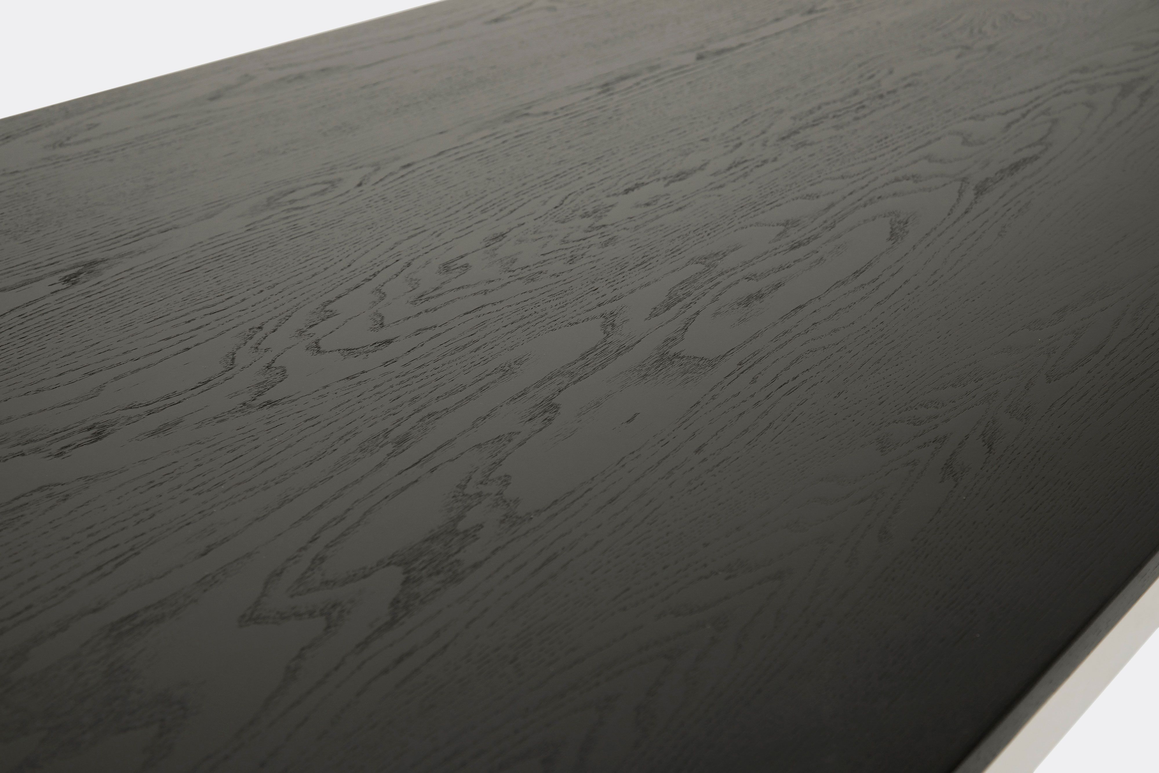 Detail of dining table with ebonized oak wood top