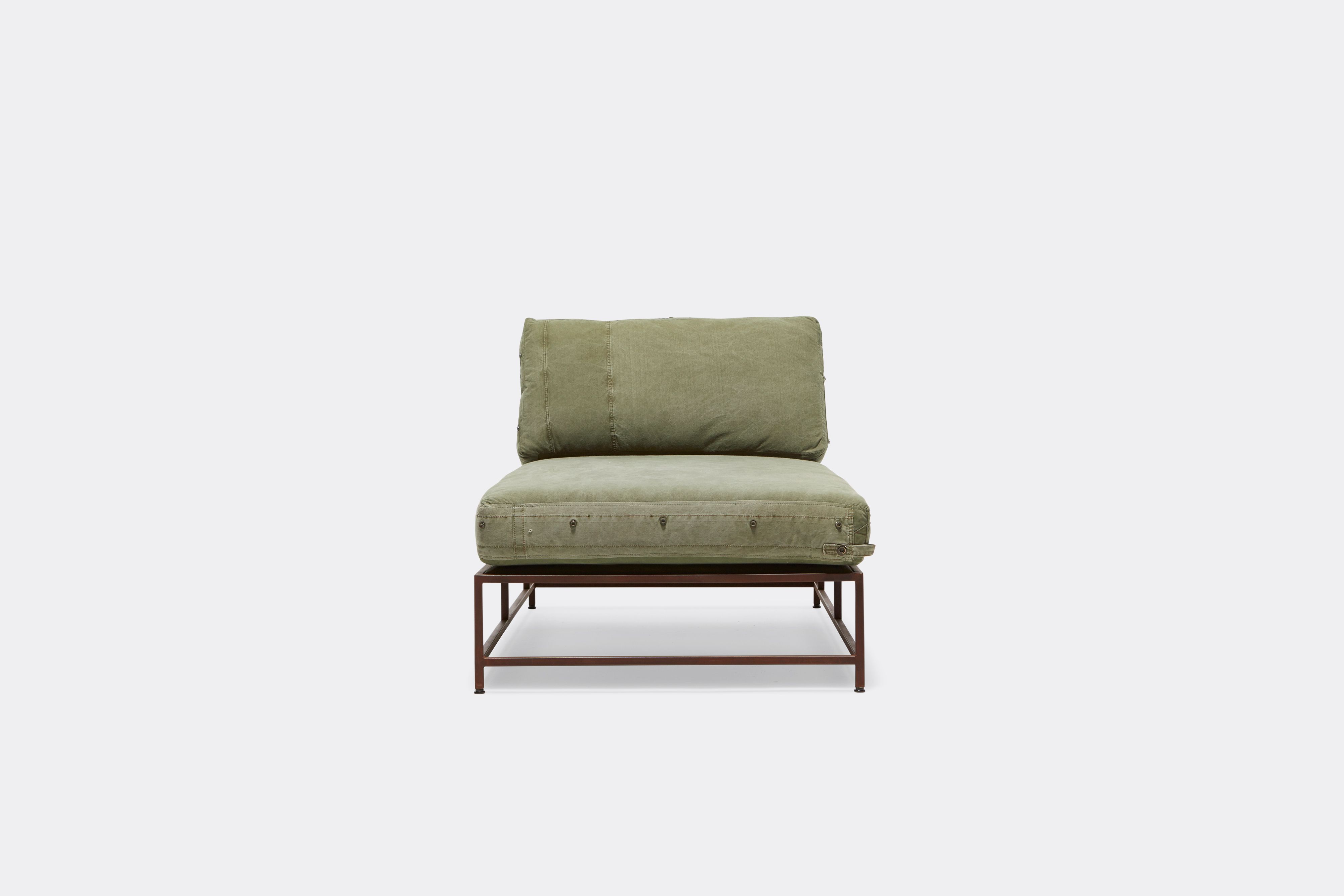 Front of lounge chaise with military canvas upholstery and marble rust metal frame