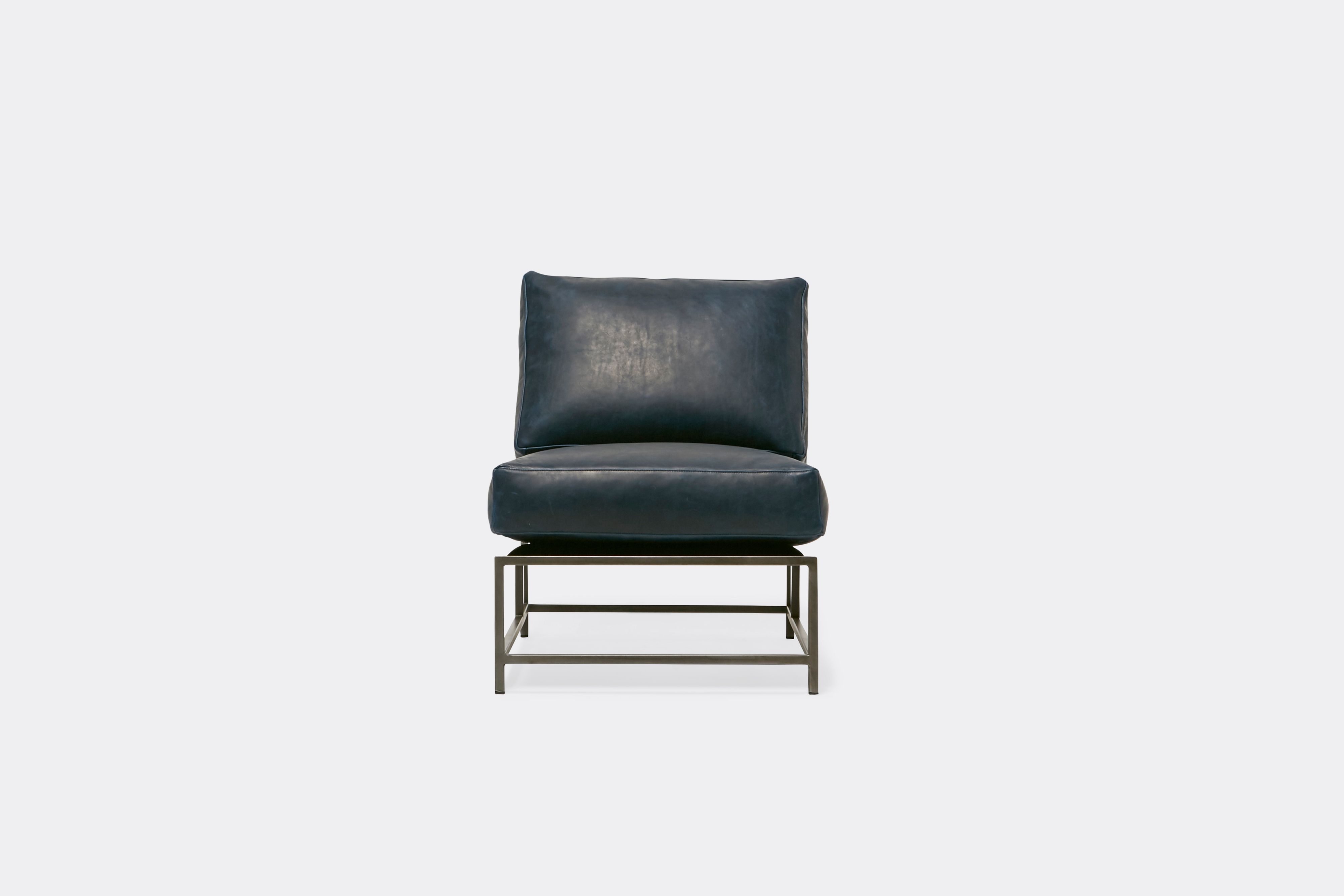 front of lounge chair with blue leather upholstery on antique nickel metal frame