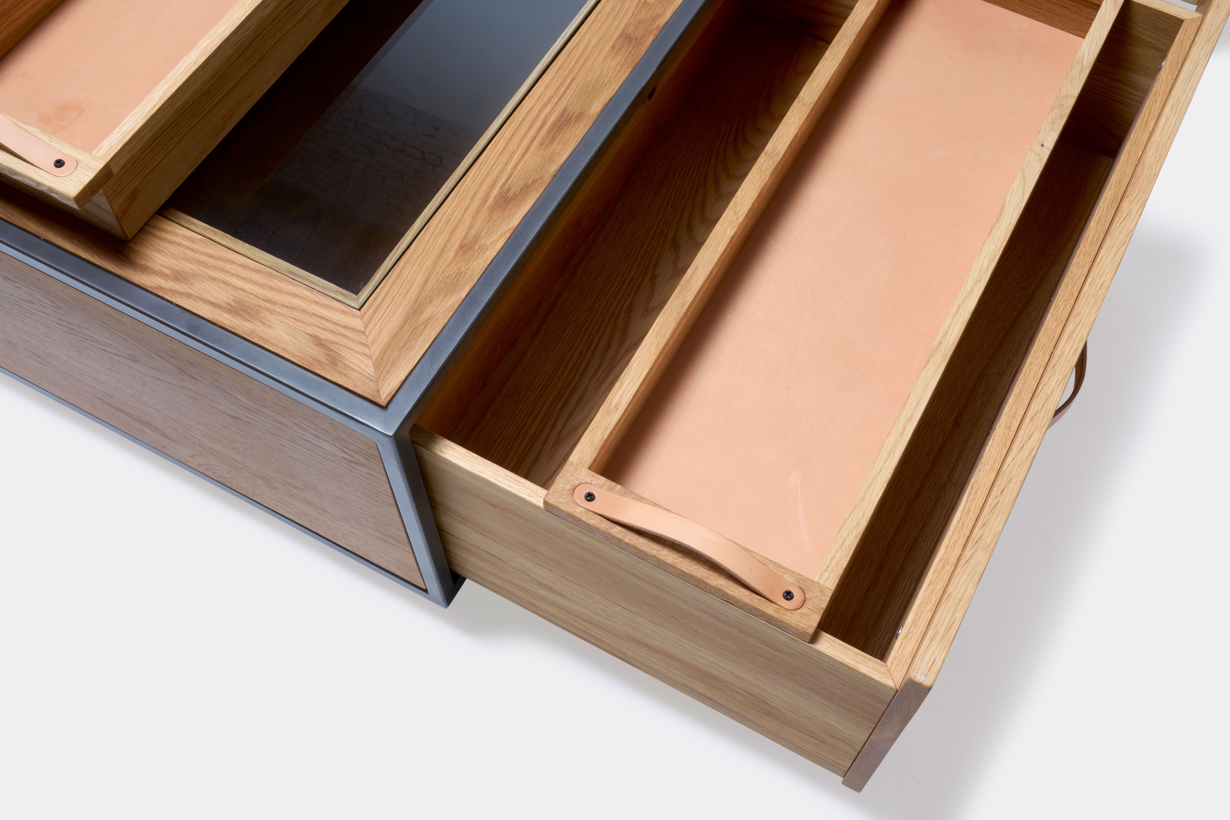 detail of double display coffee table with white oak wood, blackened steel metal and glass top