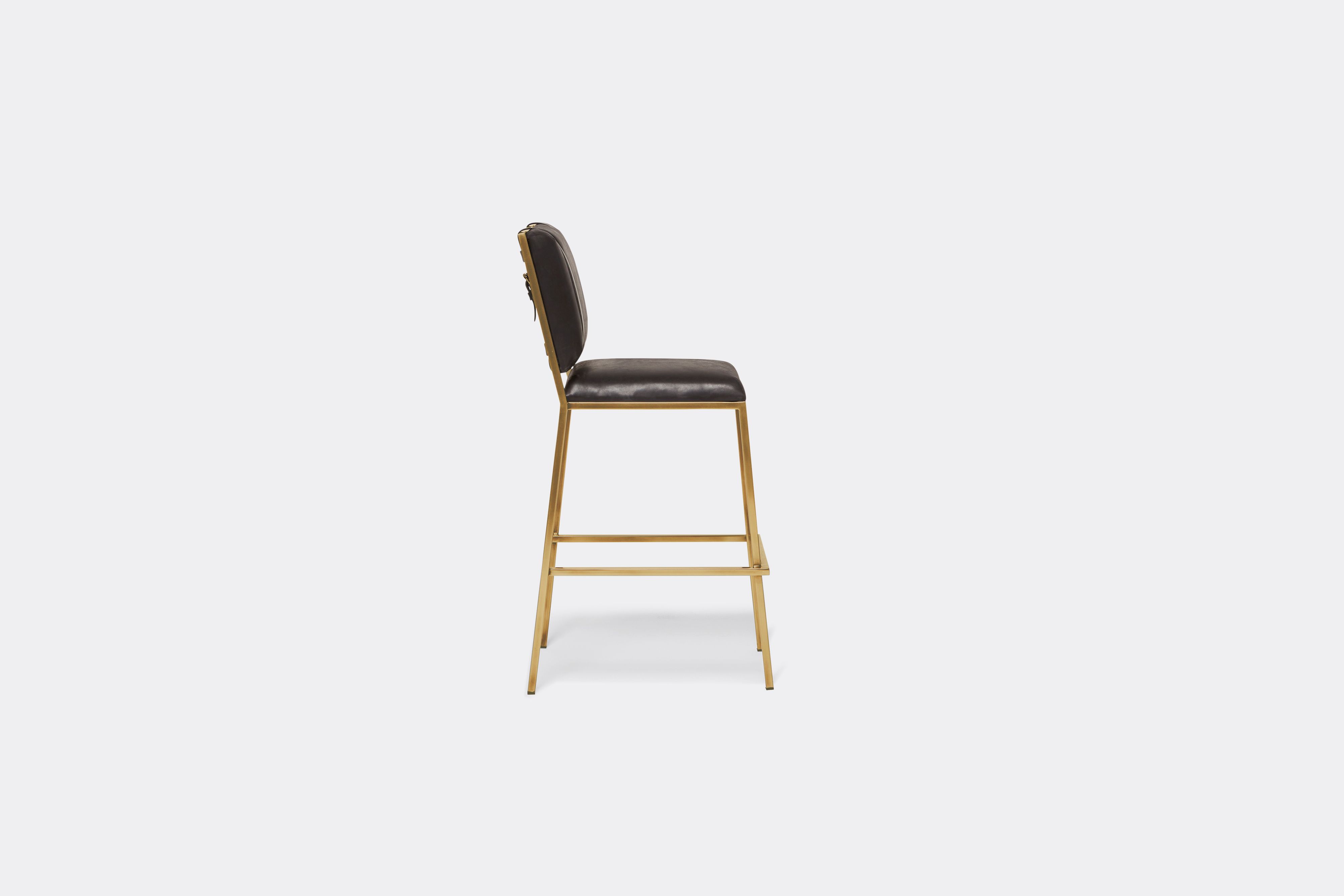 Sideview of black leather barstool with antique brass metal frame