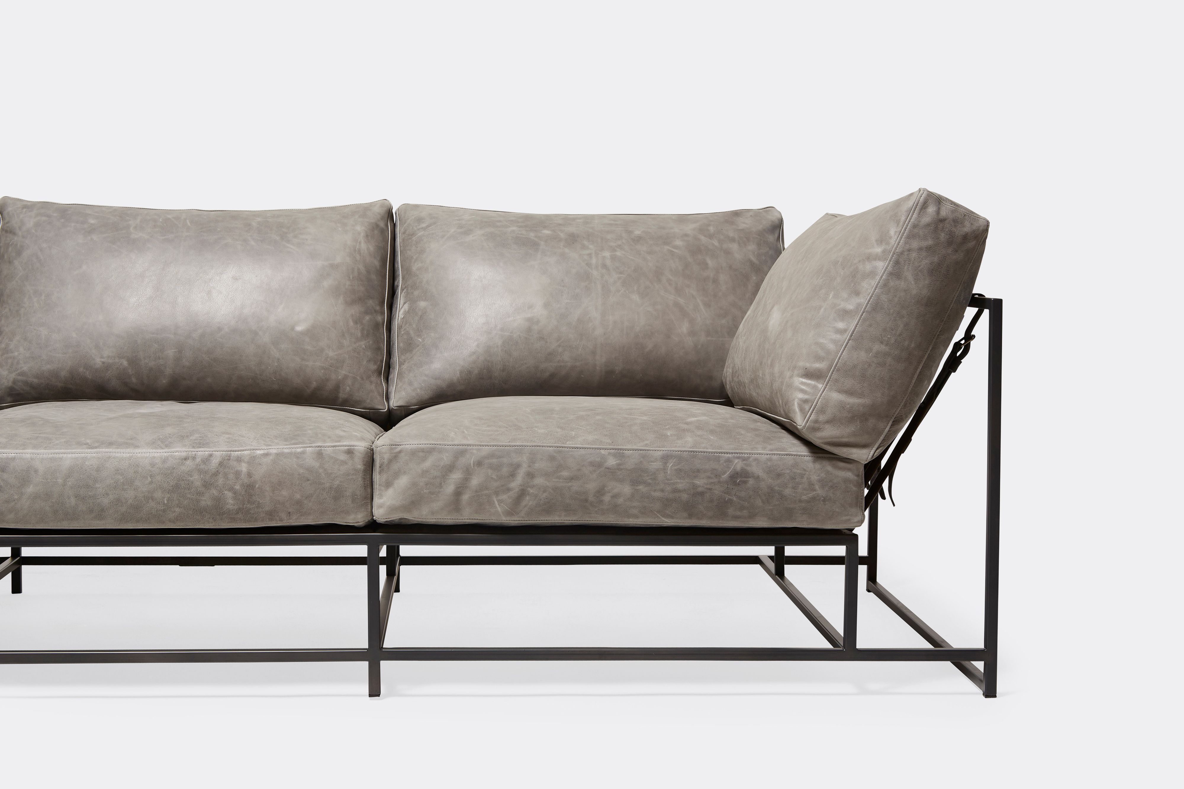 detail front of Sofa with gray leather upholstery and gray powdercoat metal frame