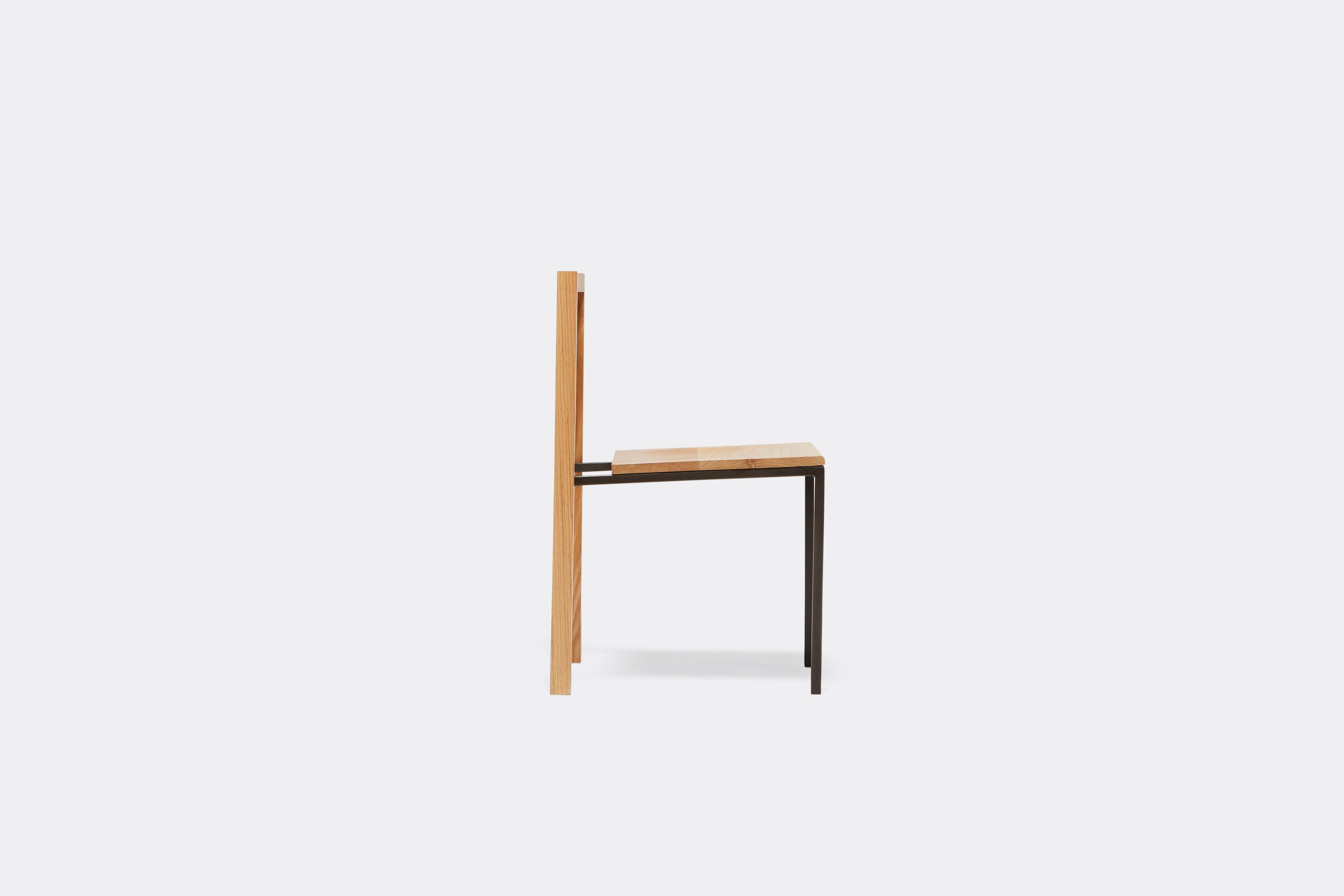 side view of oak and blackened steel dining chair