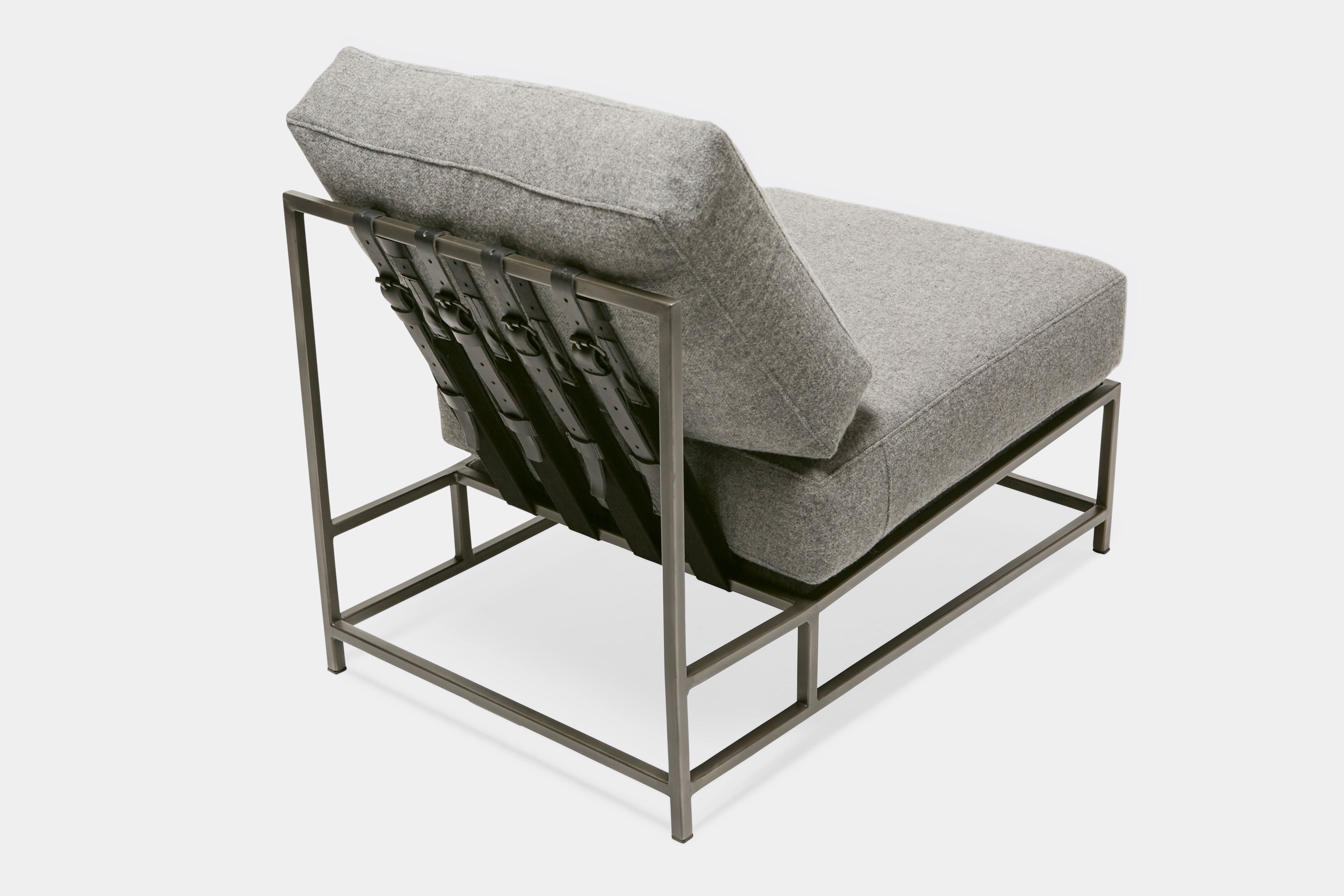 overview of lounge chair with grey wool upholstery and grey leather belts on antique nickel metal frame