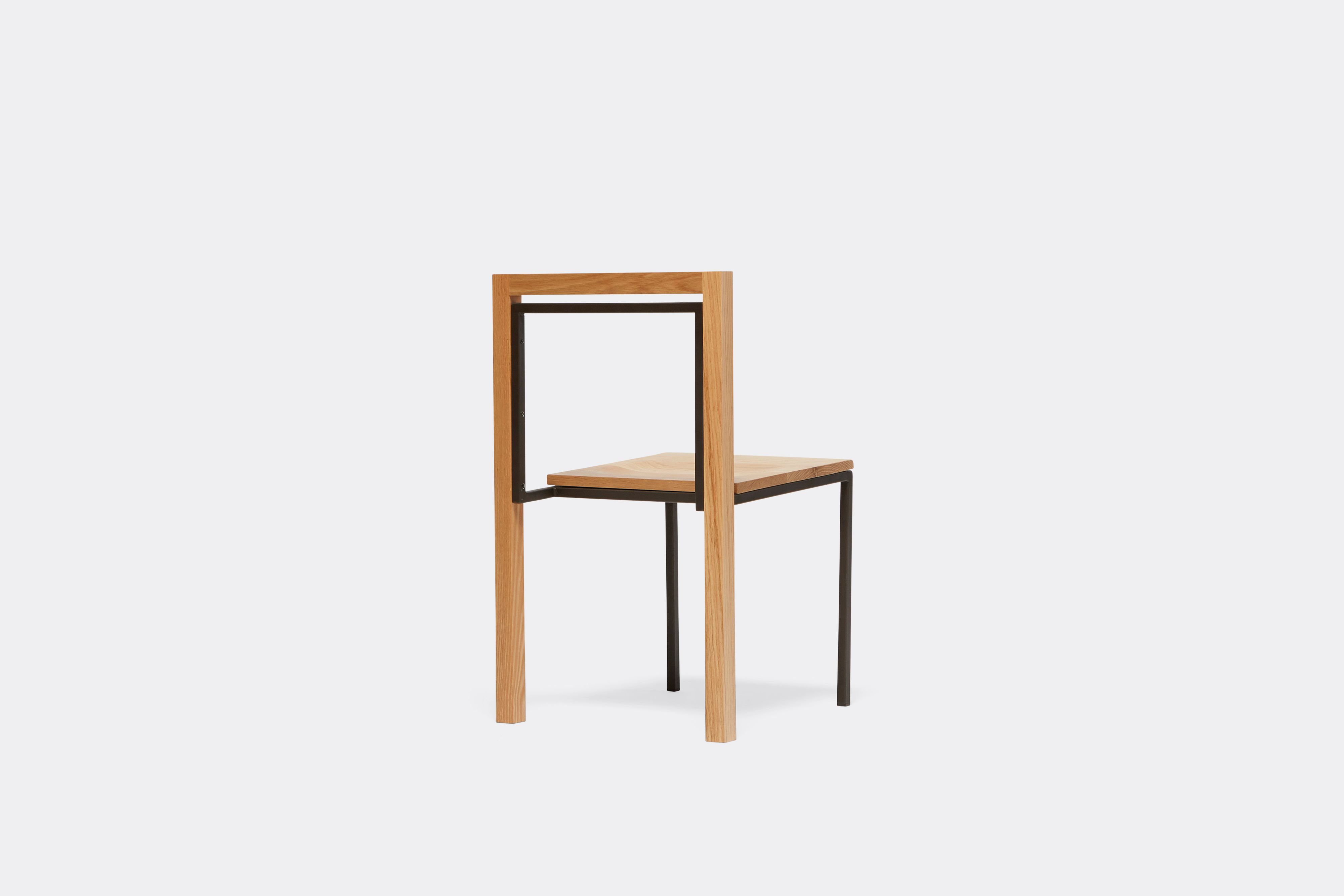 side view of oak and blackened steel dining chair