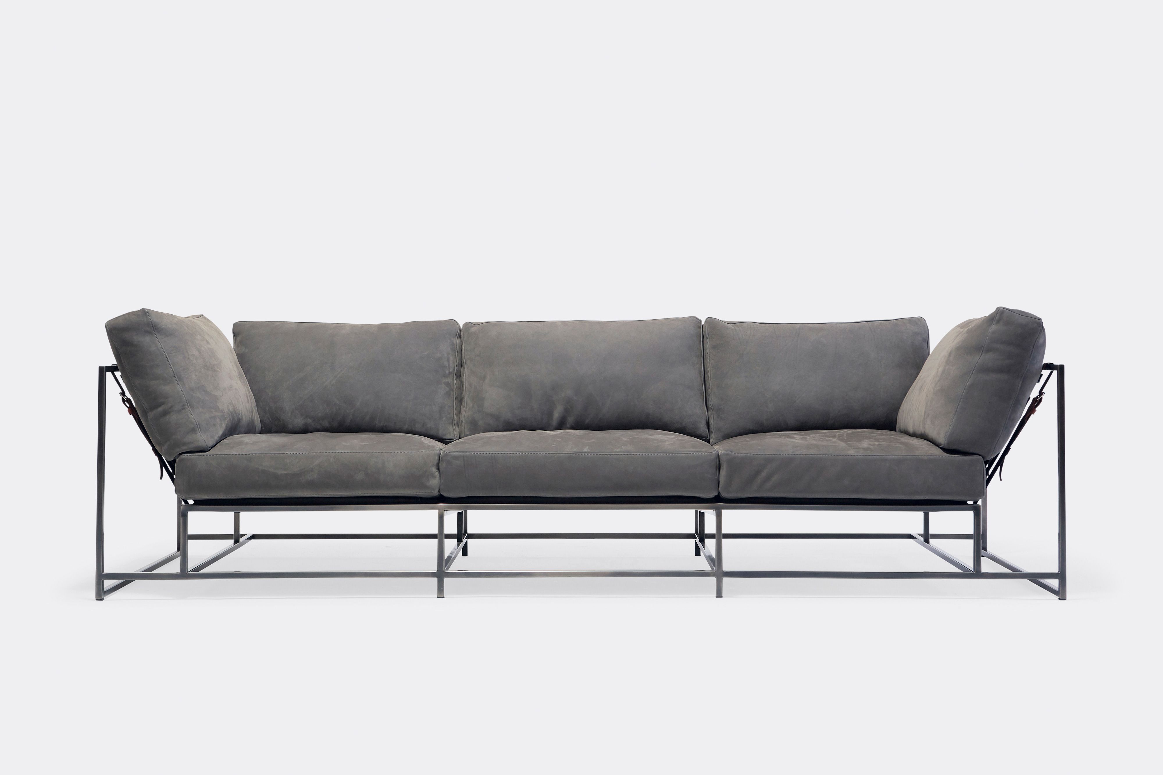 Front of sofa with grey leather upholstery and antique nickel metal frame