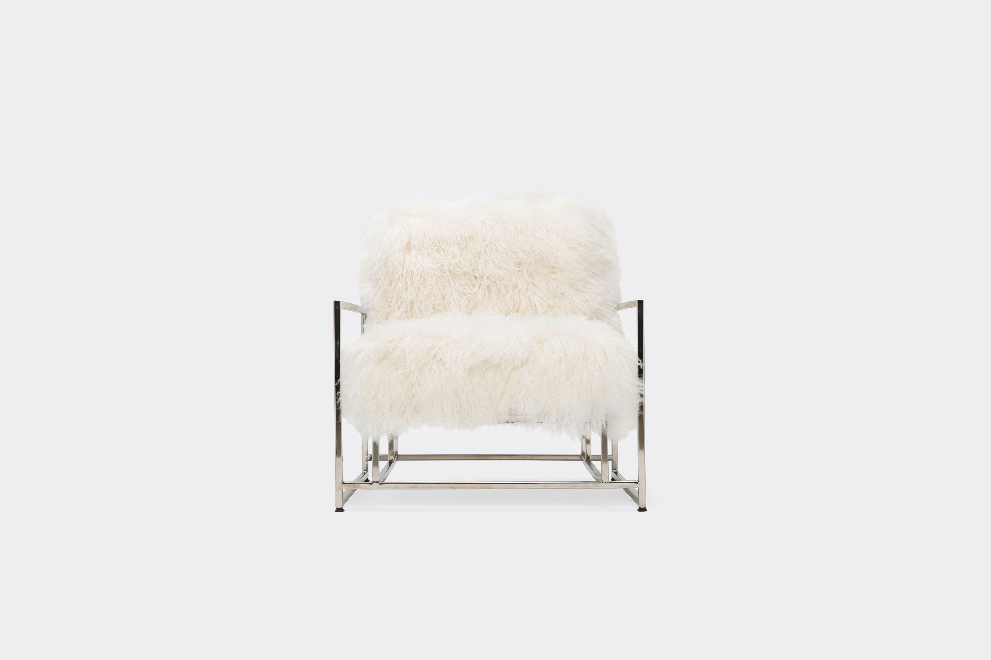front of armchair with white sheepskin upholstery on polished nickel metal frame