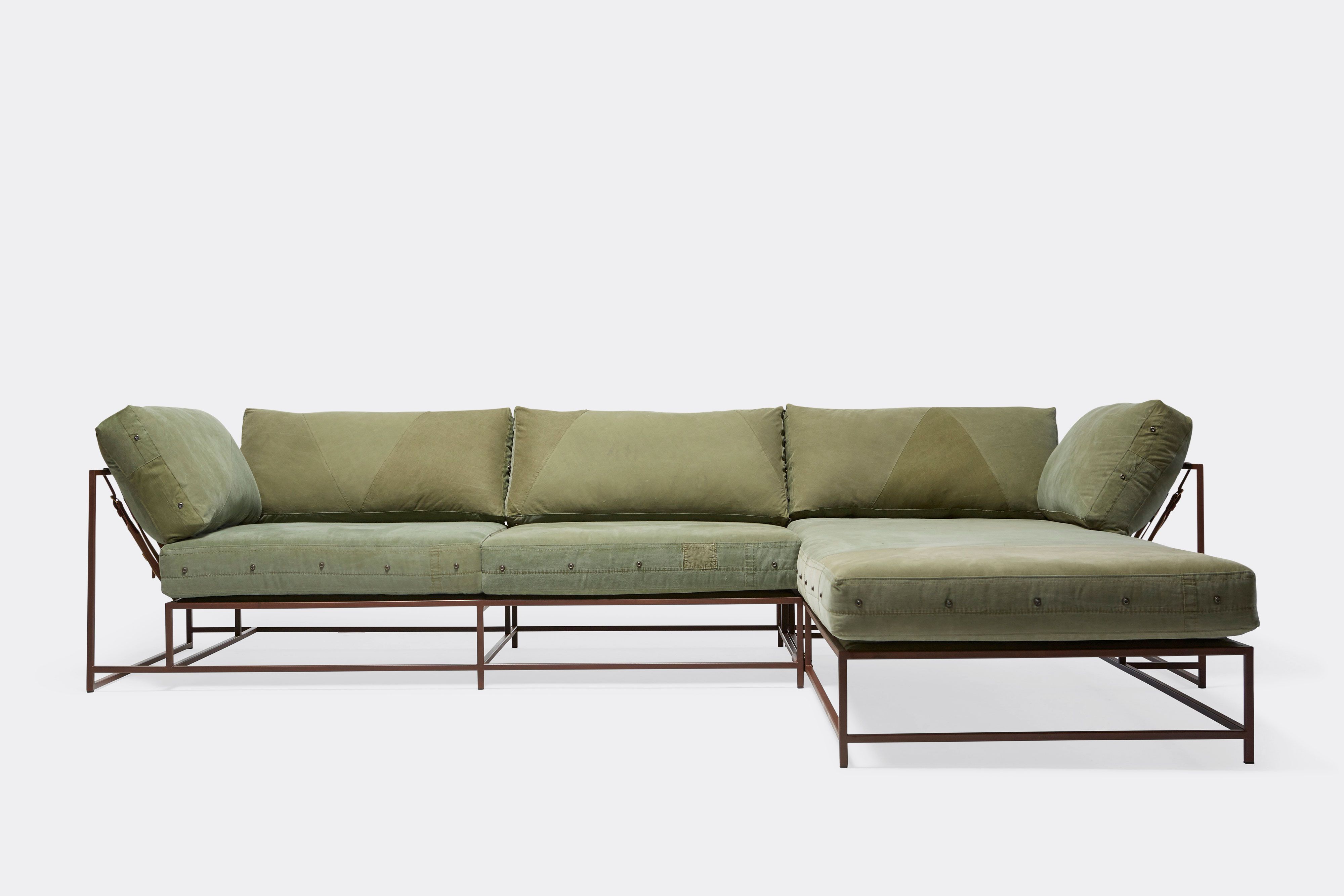 a green sectional couch with a chaise lounge on a white background .