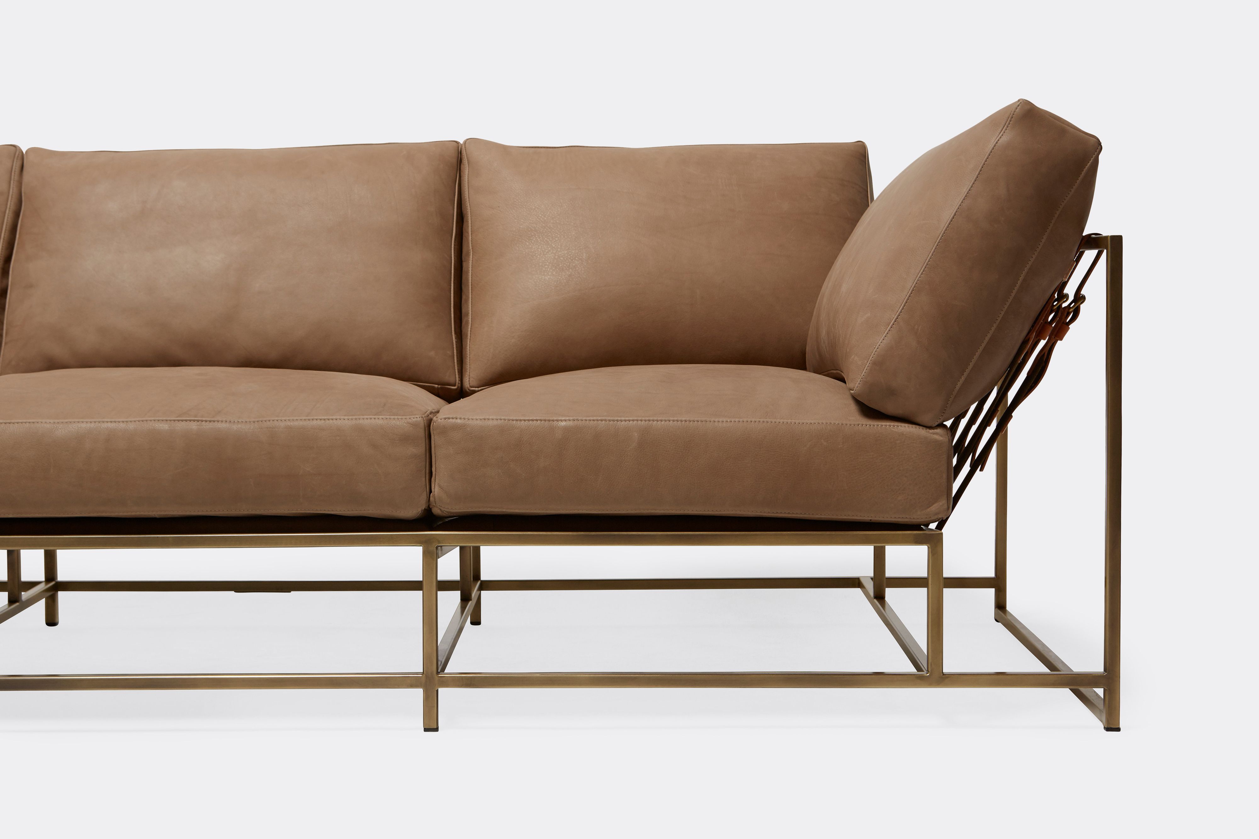 Front of Sofa with brown leather upholstery and antique brass metal frame