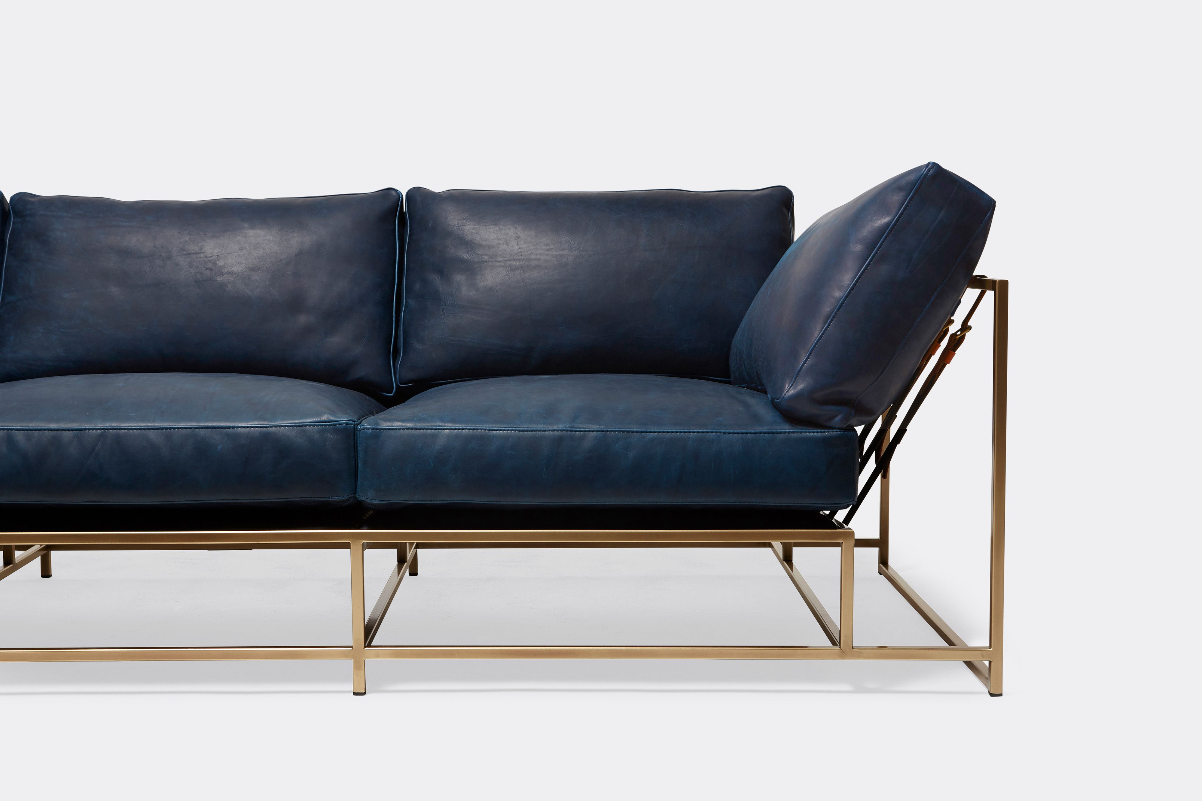 Front of Sofa with Navy leather upholstery and antique brass metal frame
