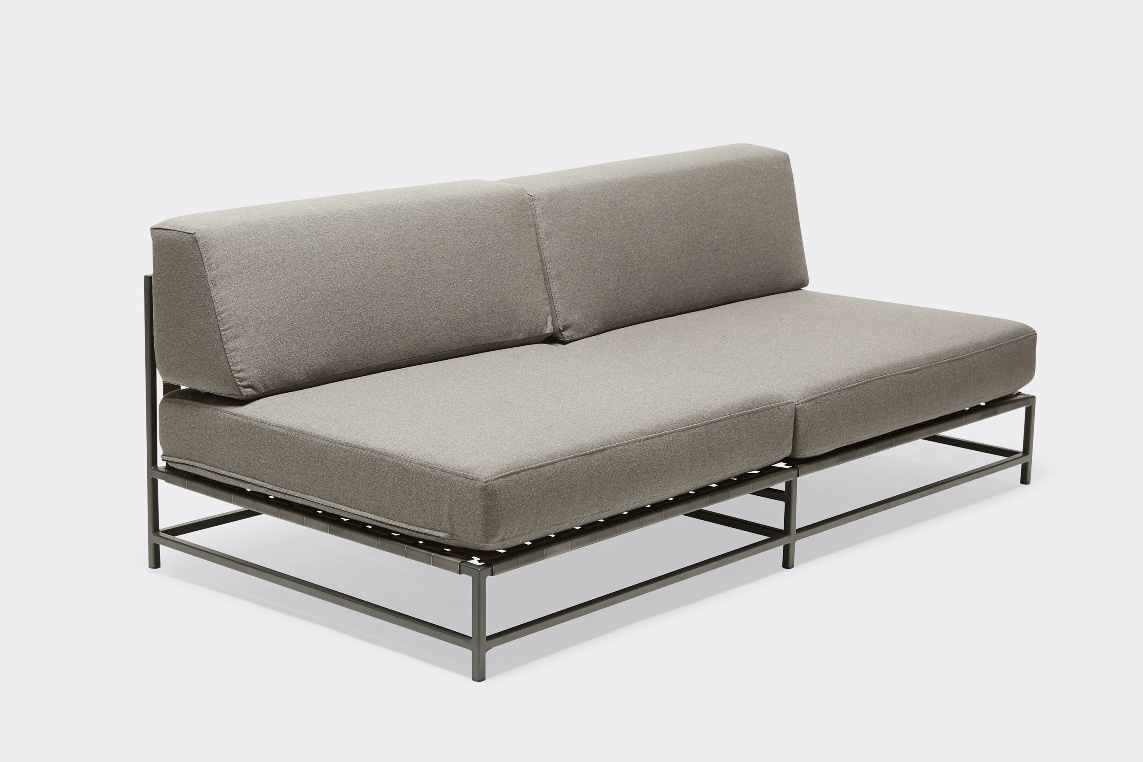 side of outdoor loveseat with grey canvas upholstery on charcoal metal frame
