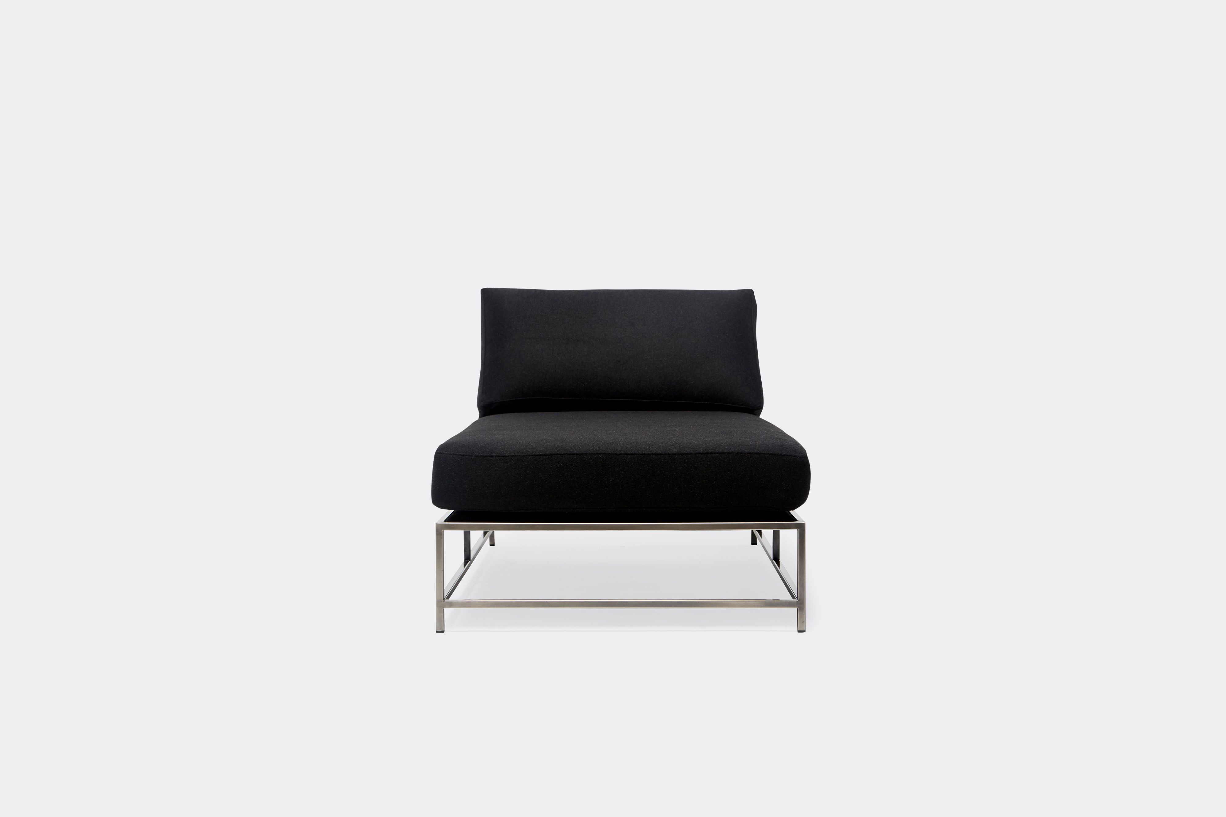 front of chaise lounge with black wool upholstery on antique nickel metal frame