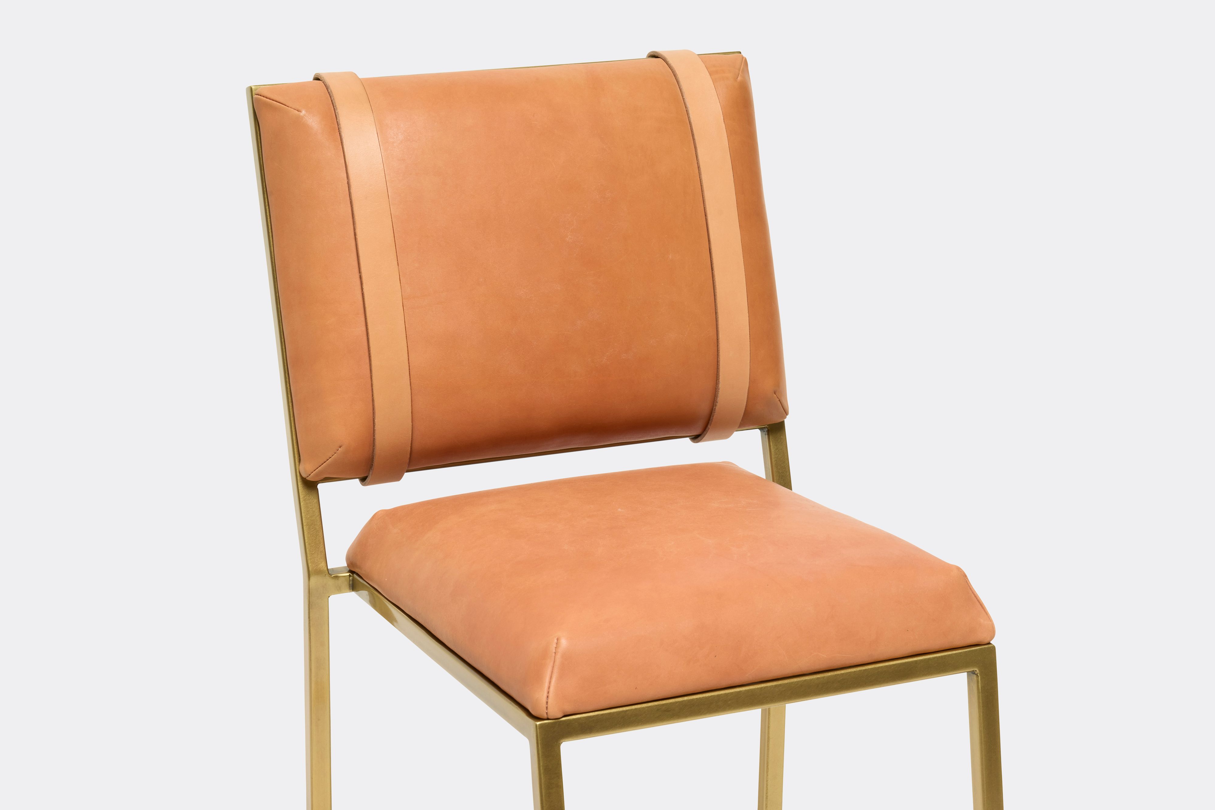 close up front view of veg tan leather barstool with antique brass metal frame
