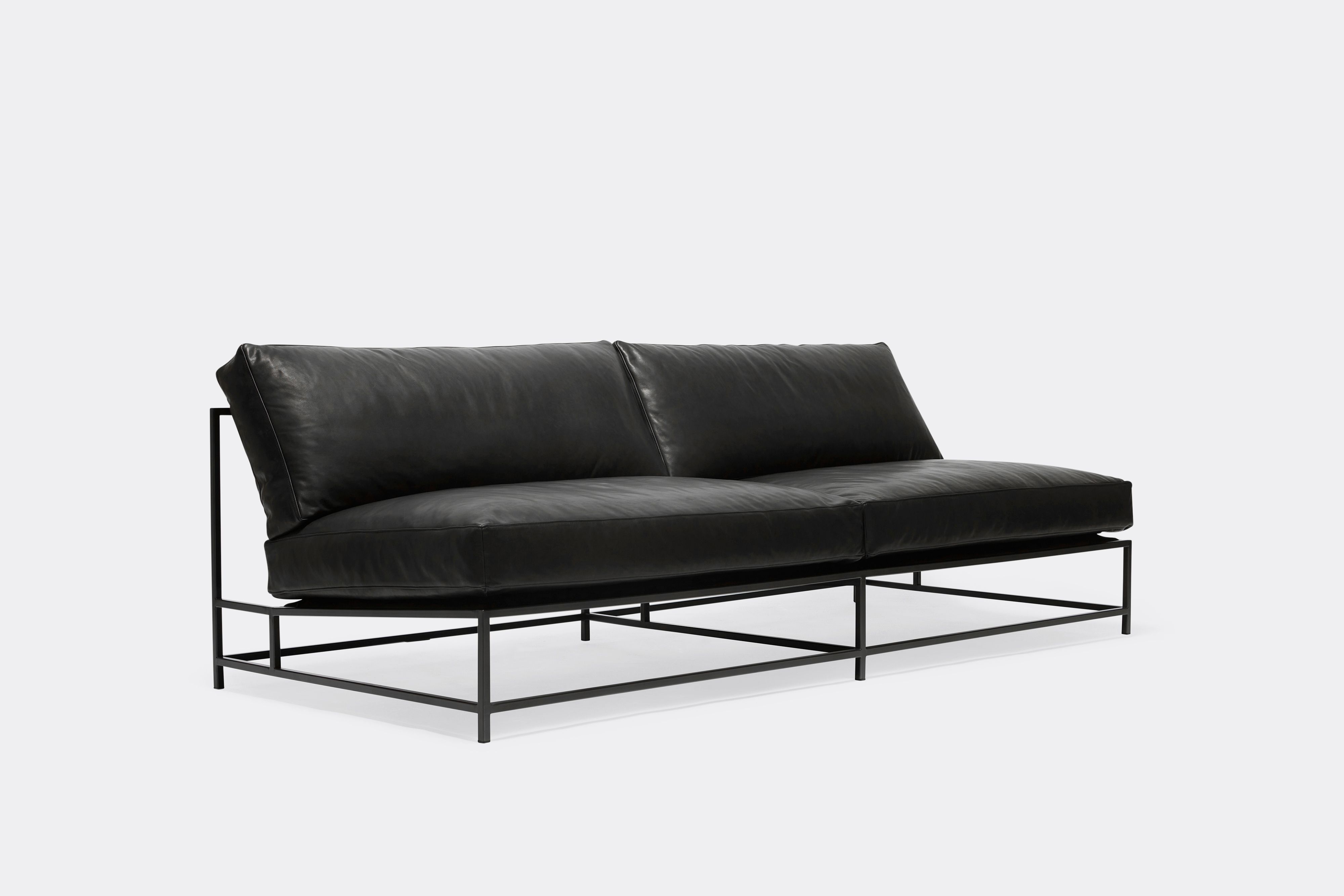 side of loveseat with black leather upholstery on black metal frame