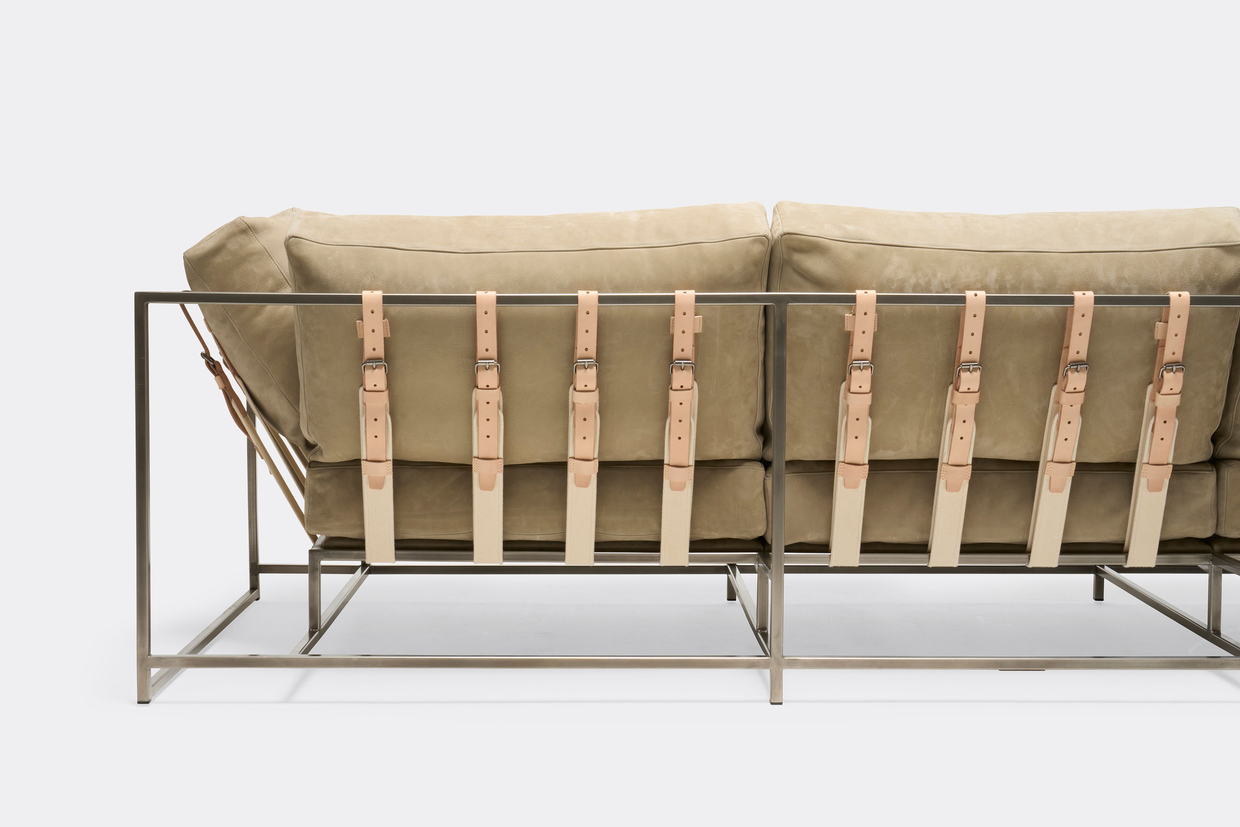 back of Sofa with tan leather upholstery and veg tan leather belts on antique nickel metal frame