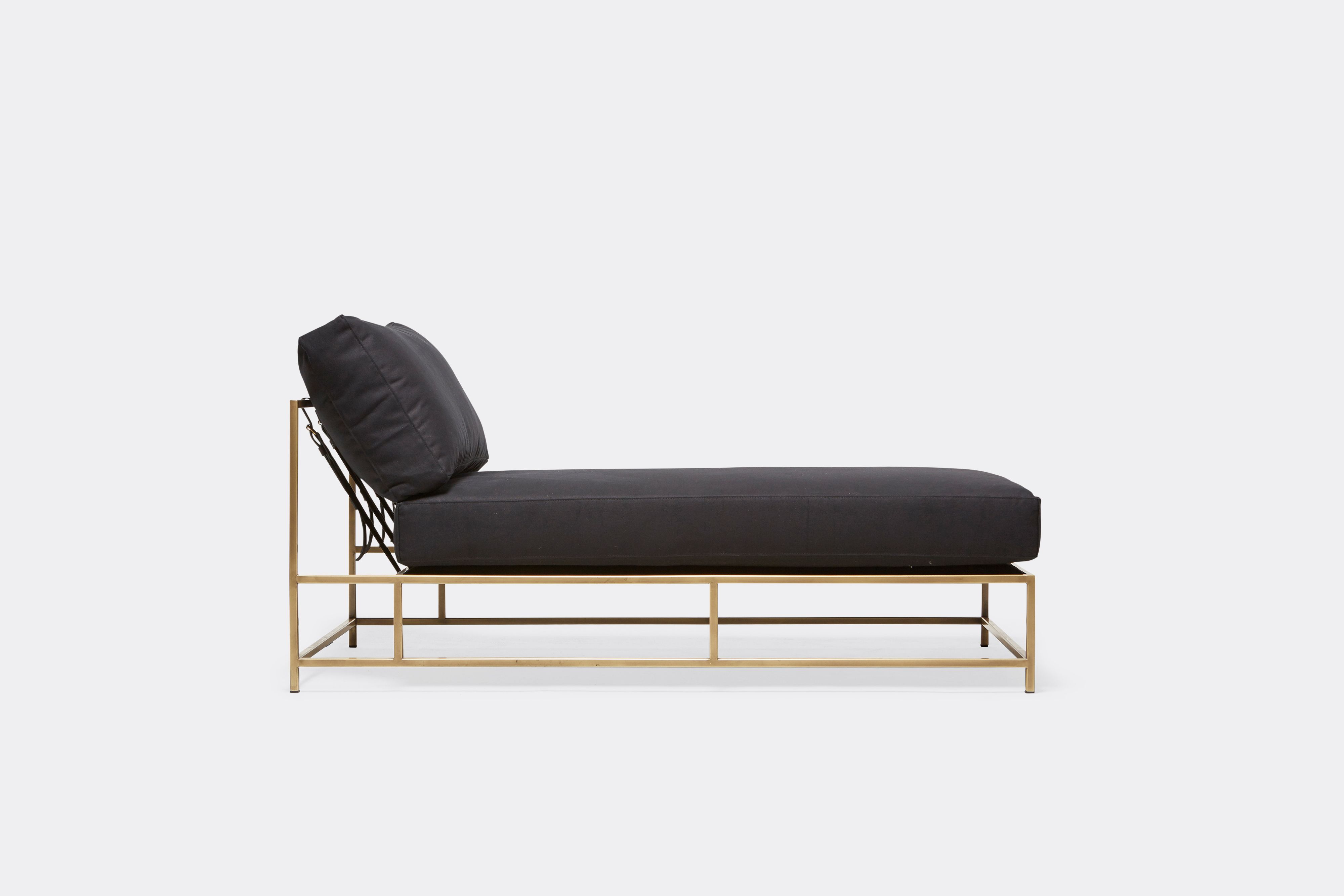 sideview of Chaise Lounge with black canvas upholstery and antique brass metal frame