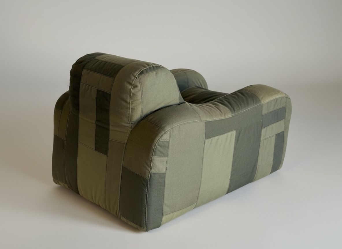 Plush, rounded armchair with a green patchwork fabric design.